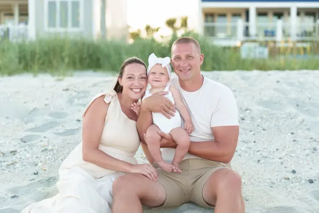 Mother and father with baby girl on the beach