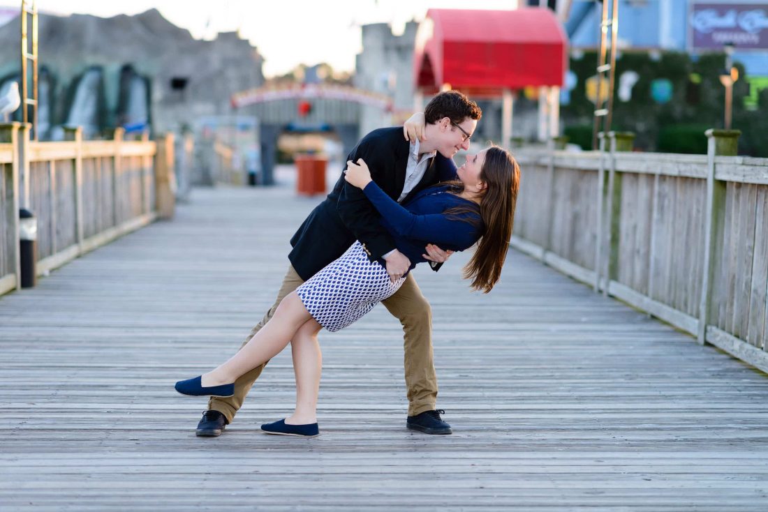 Leaning fiance back for a kiss at Broadway at the Beach in Myrtle Beach