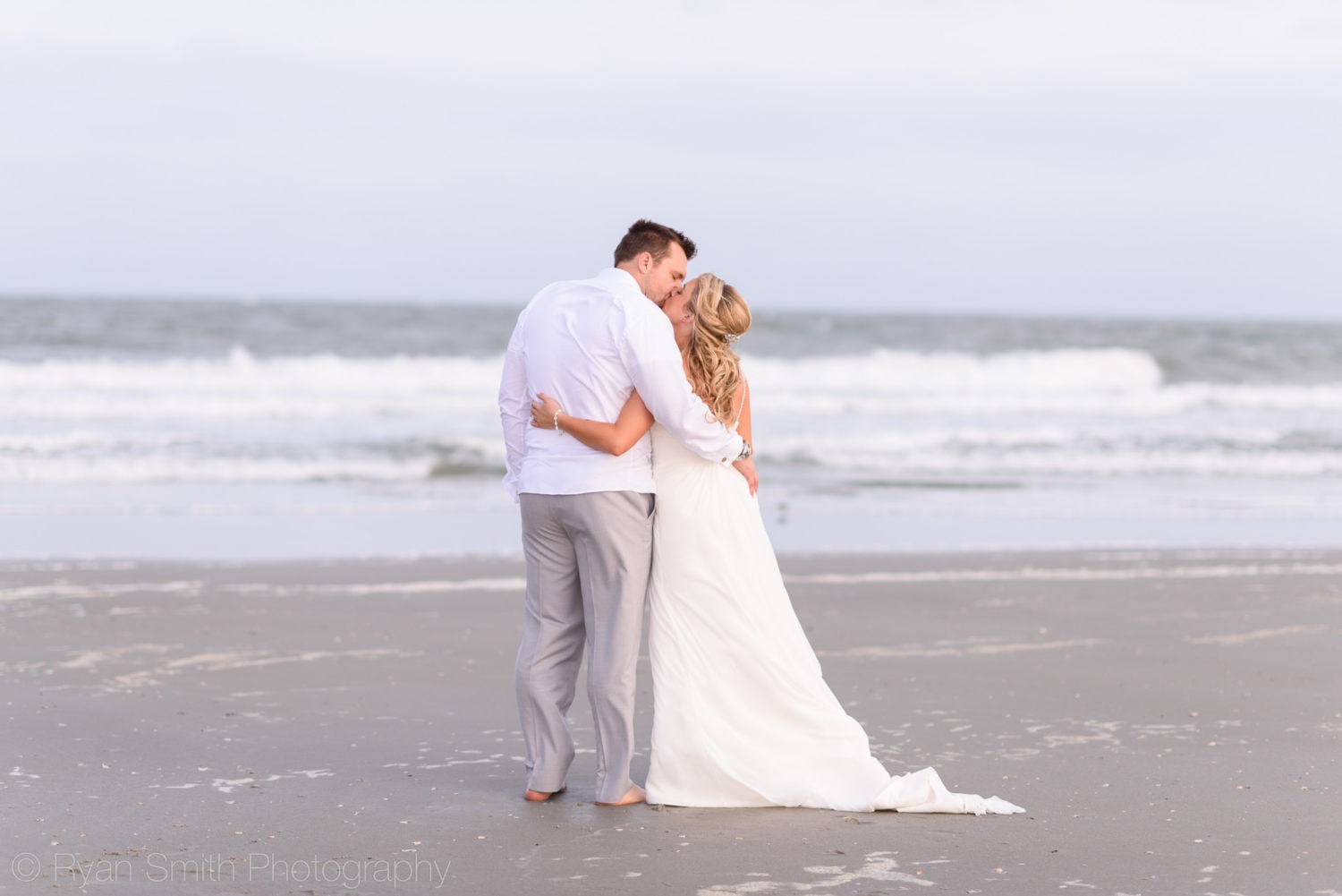Bride and groom looking out at ocean - Grande Dunes Ocean Club