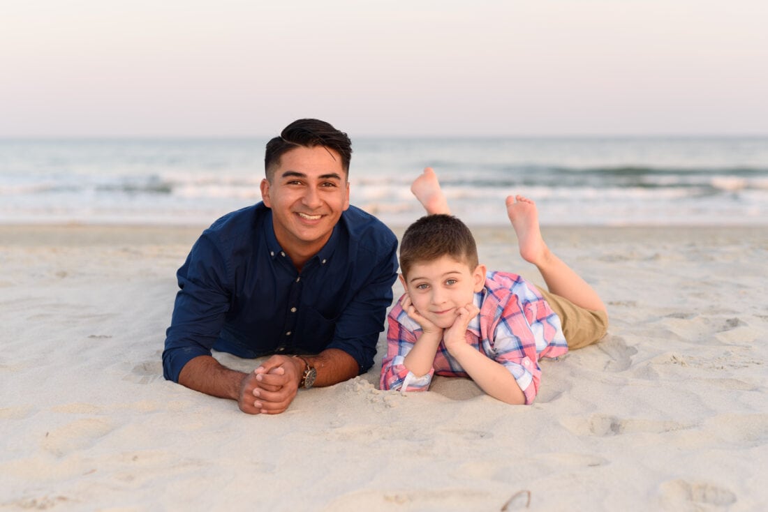 Brothers laying in the sand - Huntington Beach State Park