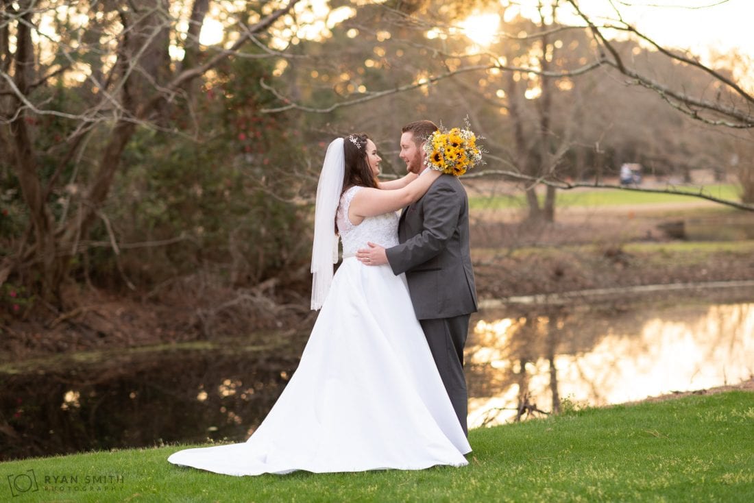 Bride with her arms around the grooms neck Litchfield Country Club