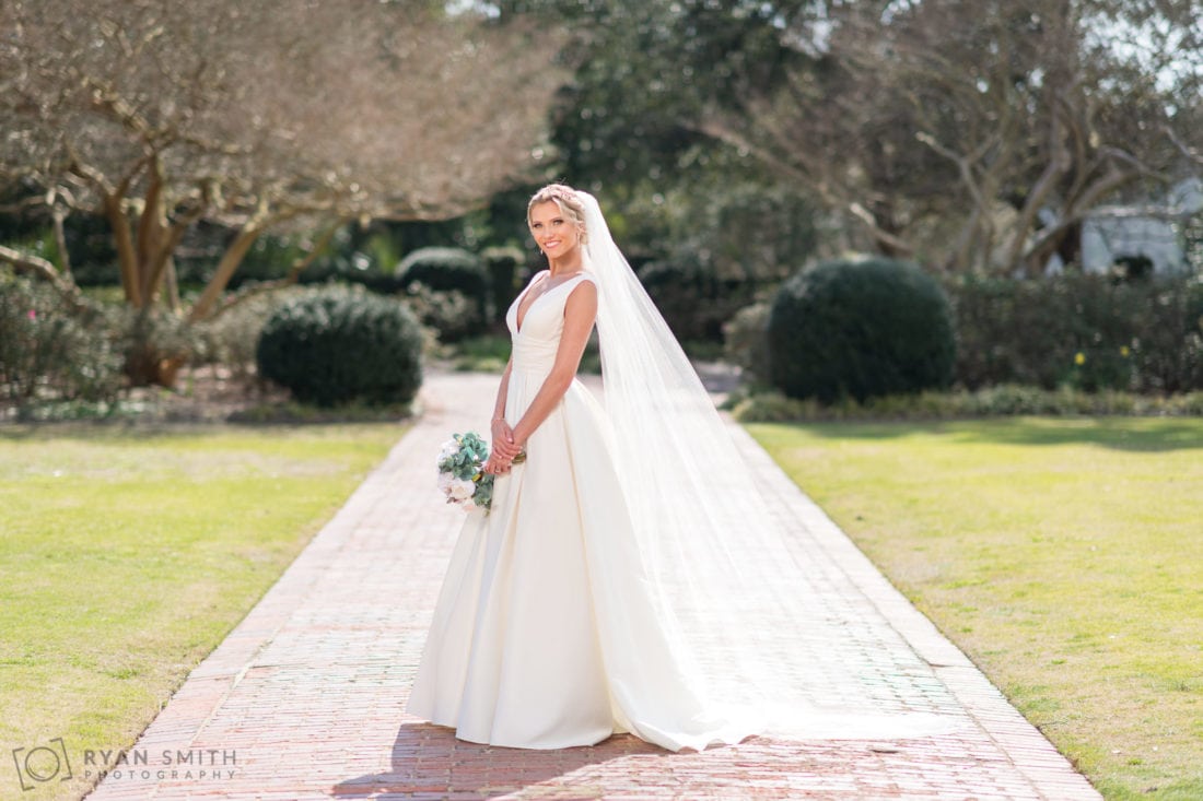 Bride backlit by the sun coming through her veil using fill flash - Pine Lakes Country Club