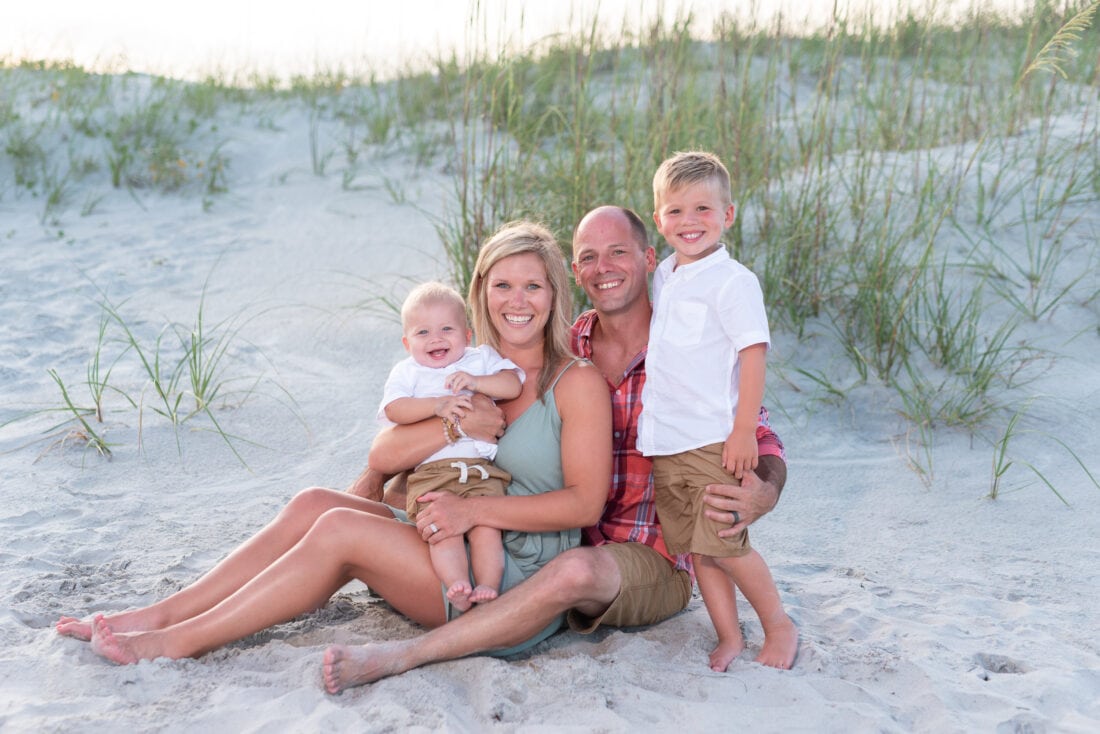 Family of 4 sitting by the dunes - Huntington Beach State Park