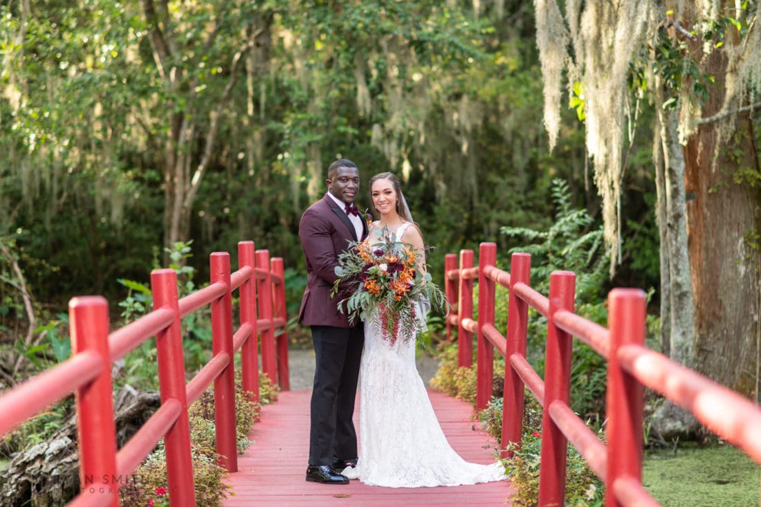 Portraits of bride and groom on the red bridge - Magnolia Plantation - Charleston, SC