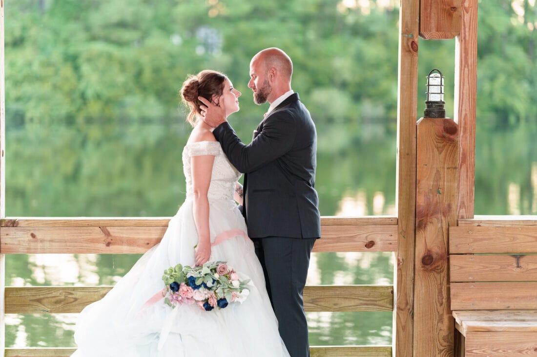 Bride and groom with rim light from the sunset on the gazebo - The Pavilion at Pepper Plantation