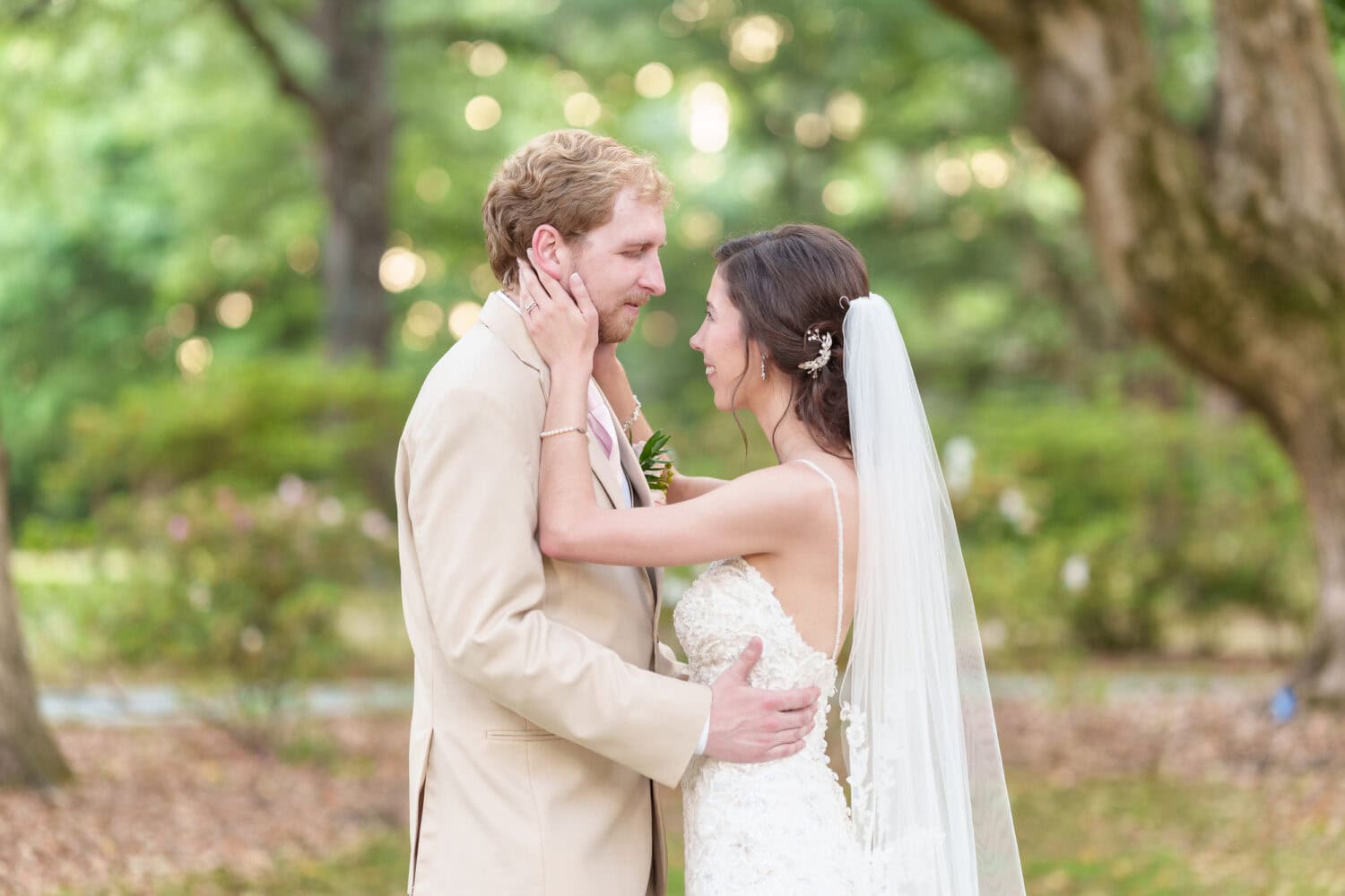 Pulling groom in for a kiss with the bokeh from the sunset - Tanglewood Plantation