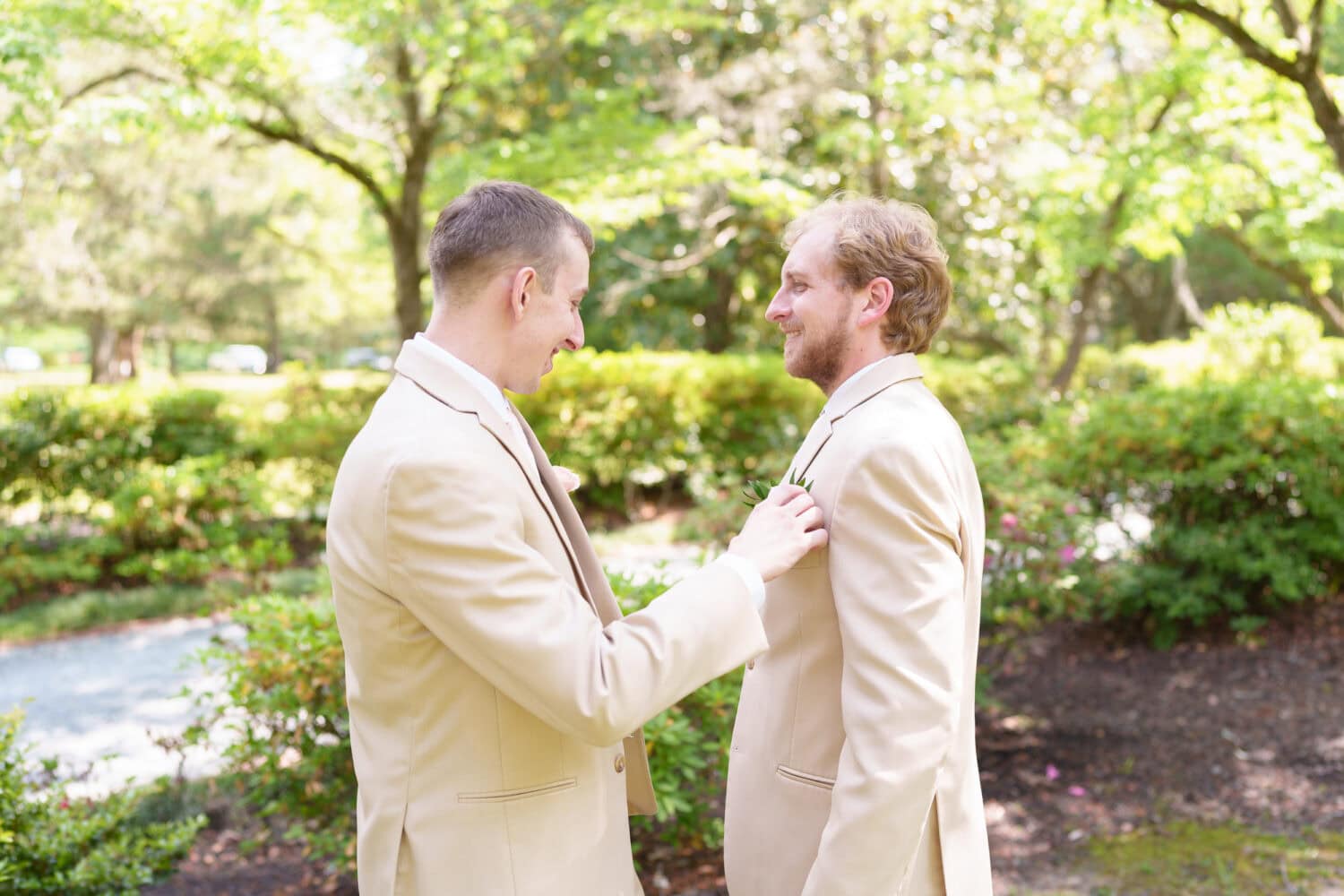 Putting on groom's boutonniere - Tanglewood Plantation