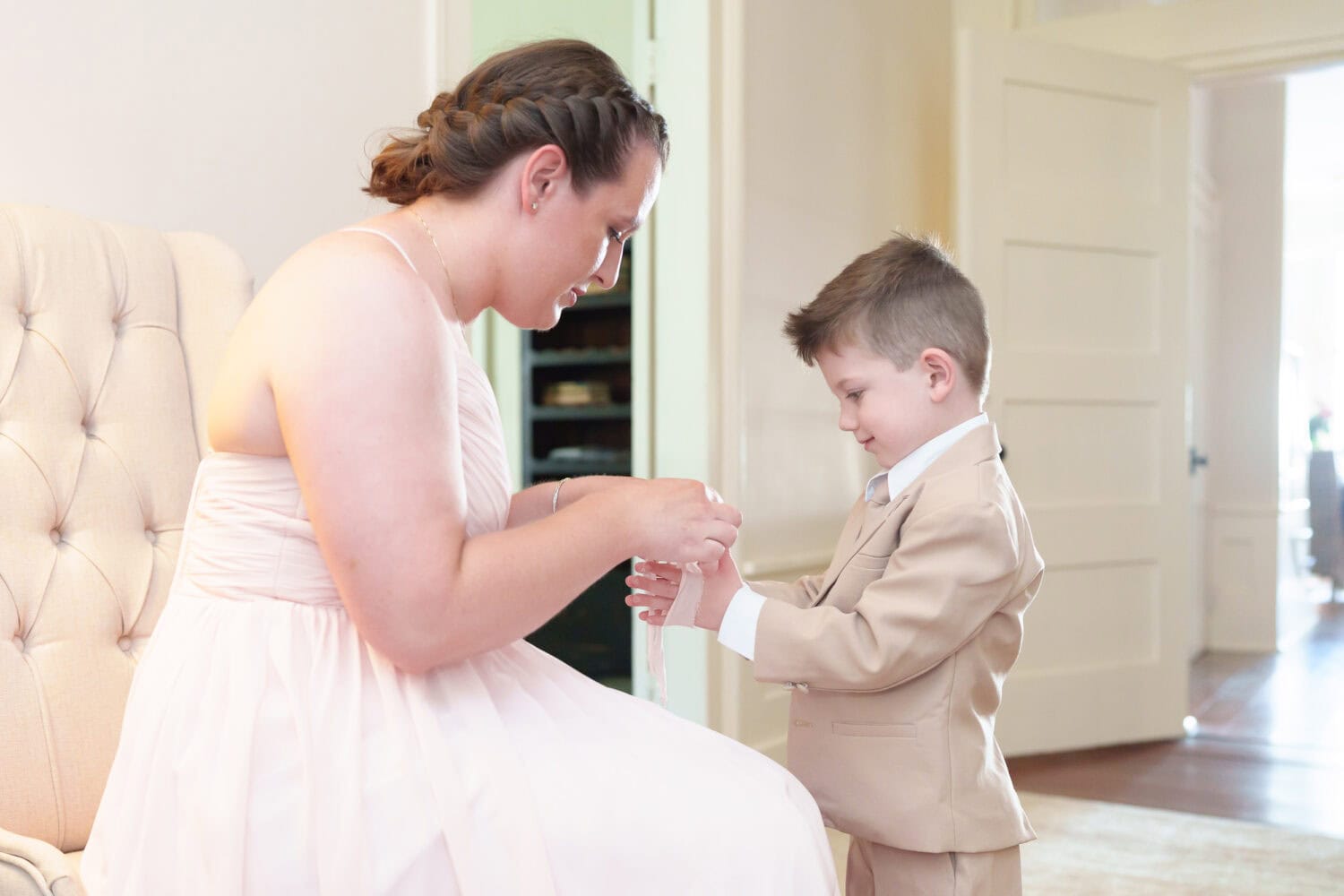 Ring bearer helping mom tie a bow - Tanglewood Plantation