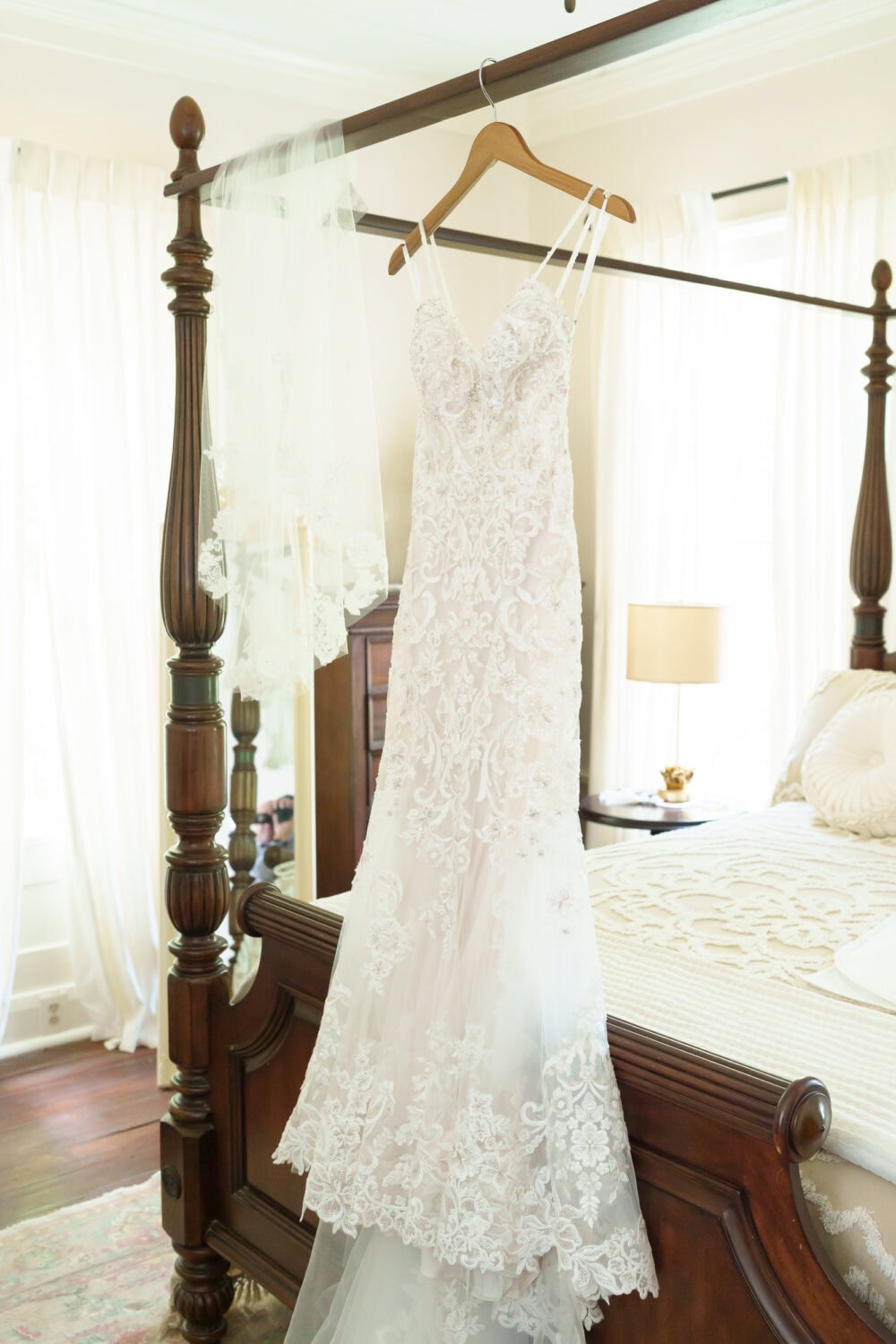 Wedding dress hanging hanging from the bed - Tanglewood Plantation