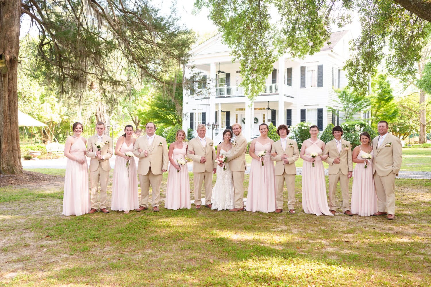 Wedding party with guys and girls grouped together in front of the hose - Tanglewood Plantation