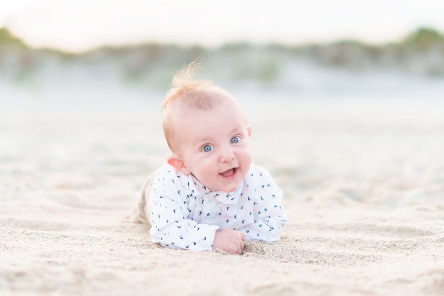 5 Month old laying in the sand with a big smile - Huntington Beach State Park