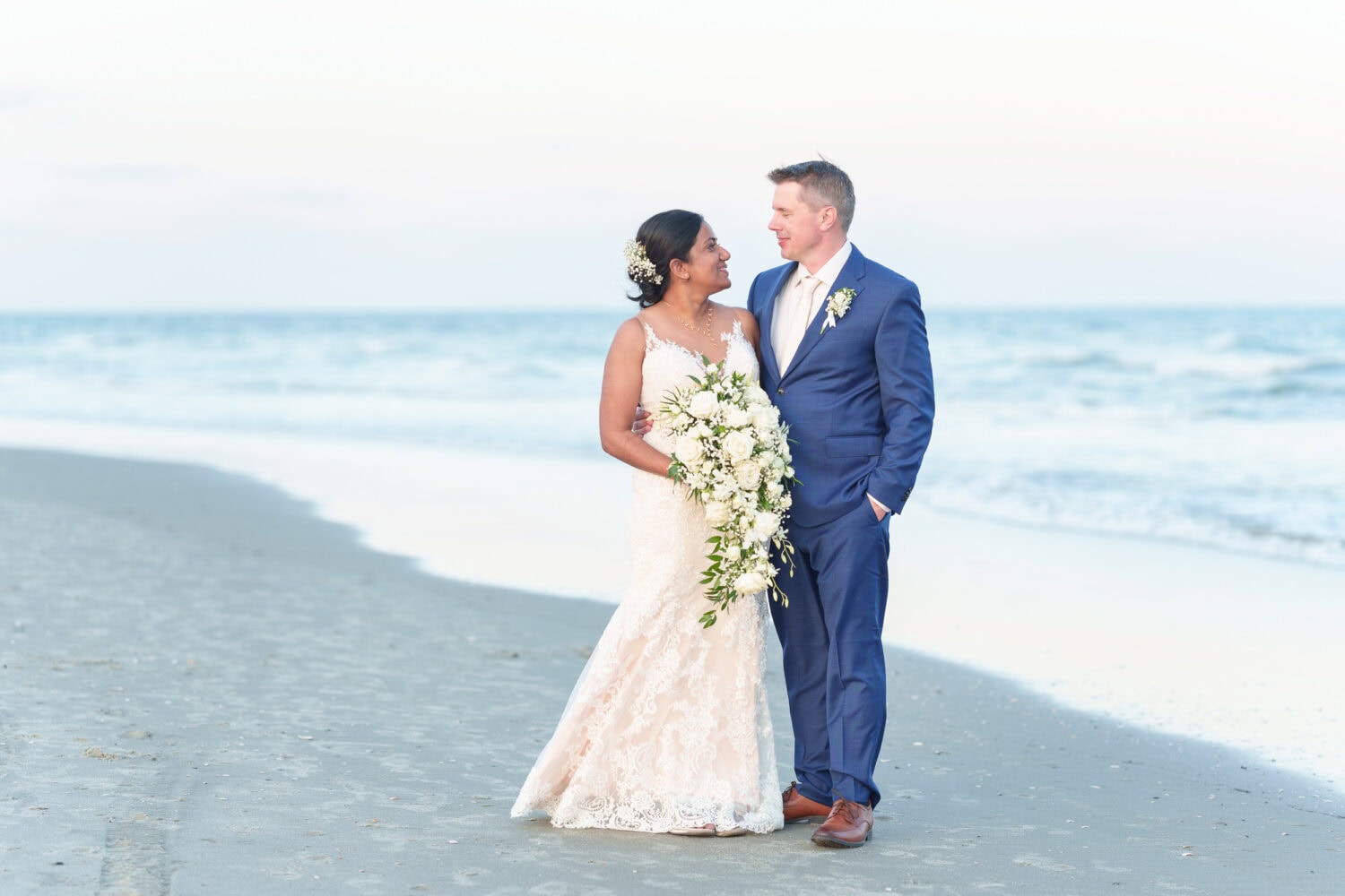 Bride and groom in front of the ocean at sunset - 21 Main Events