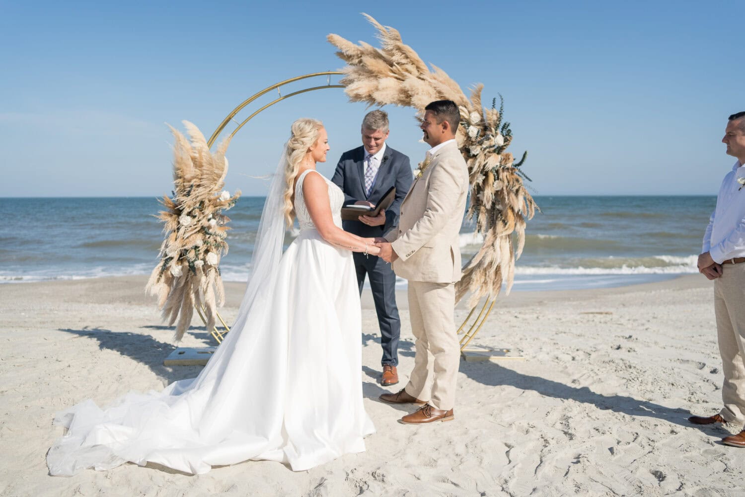 Bride and groom in front of the wedding arch - Pawleys Island