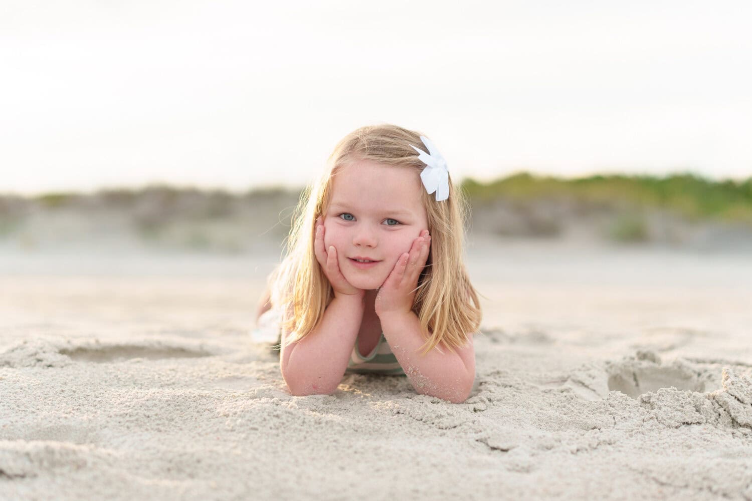 Little girl laying in the sand - Huntington Beach State Park