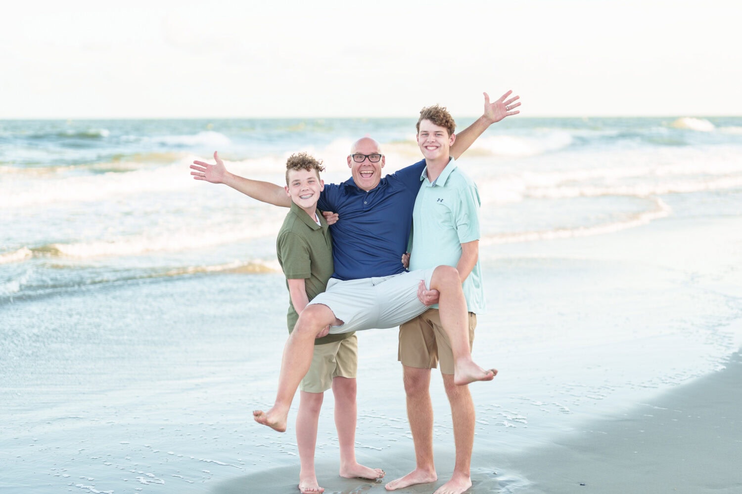Sons lifting dad into the air - North Myrtle Beach