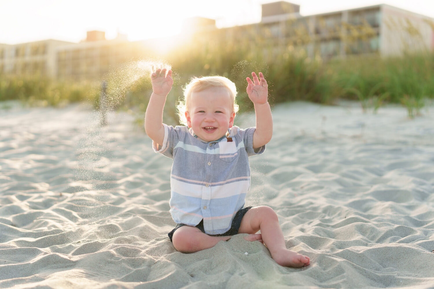 Baby throwing sand in the sunset - North Myrtle Beach