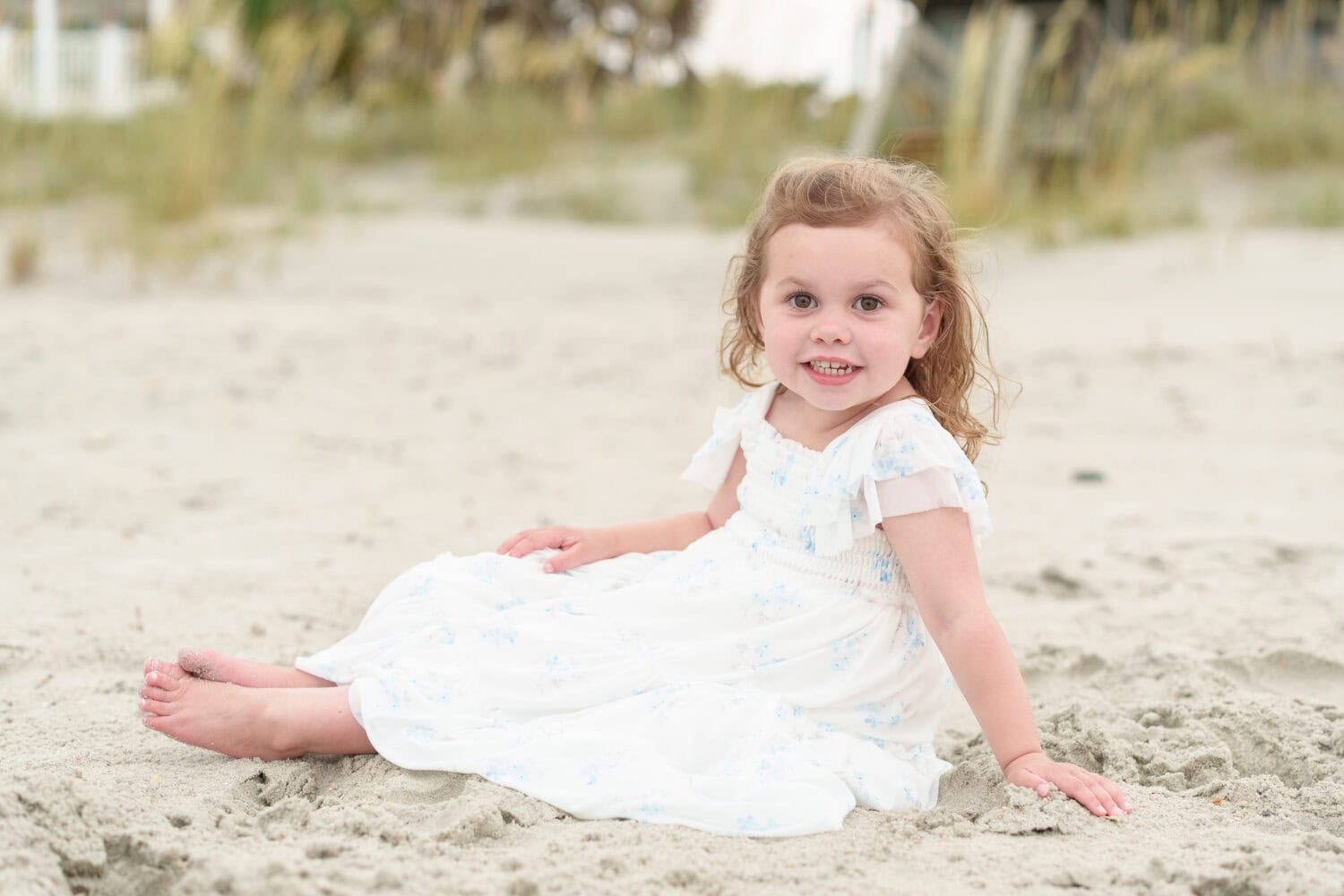 Little girl sitting in the sand - Garden City Beach