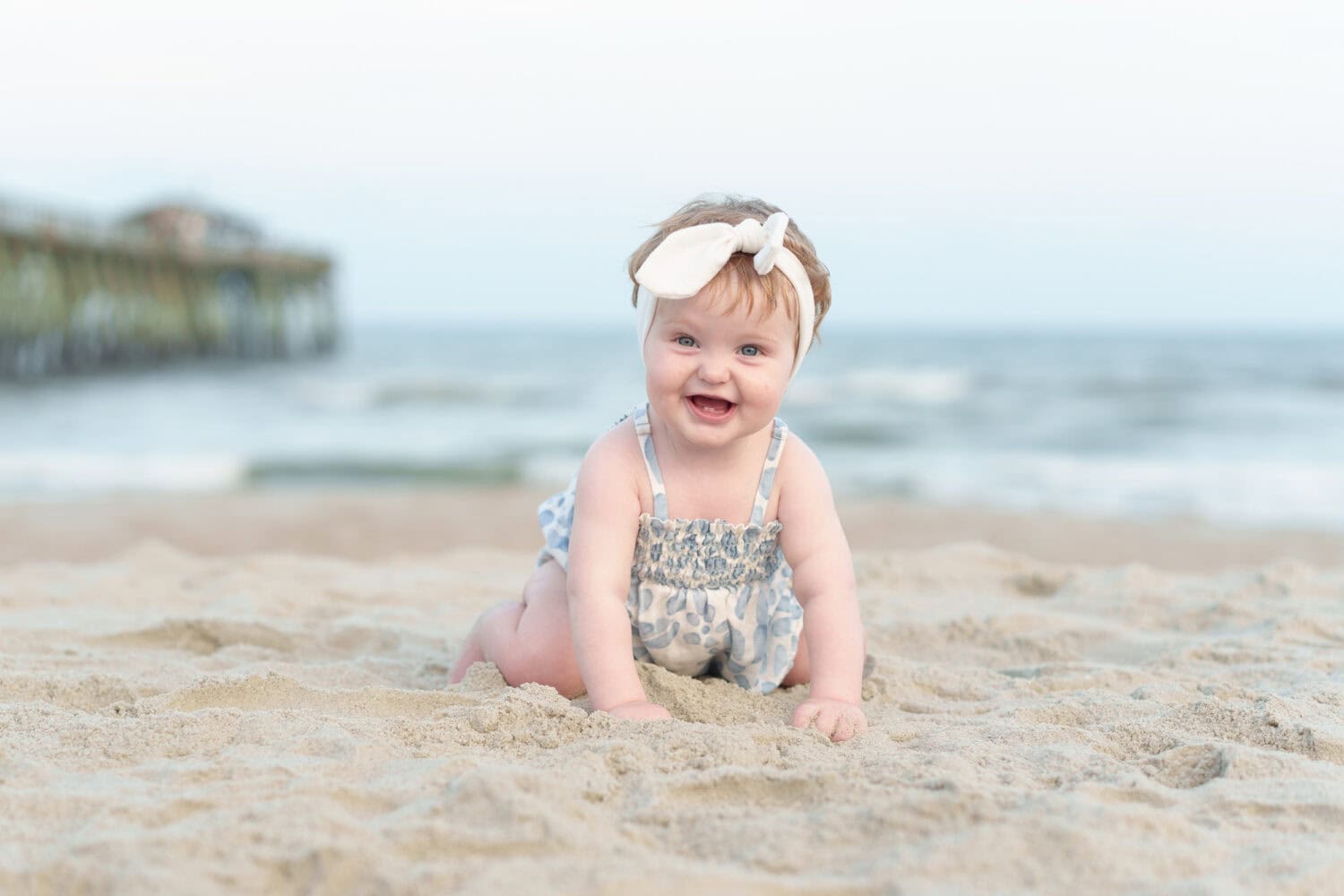 Baby girl by the ocean and pier - Myrtle Beach State Park