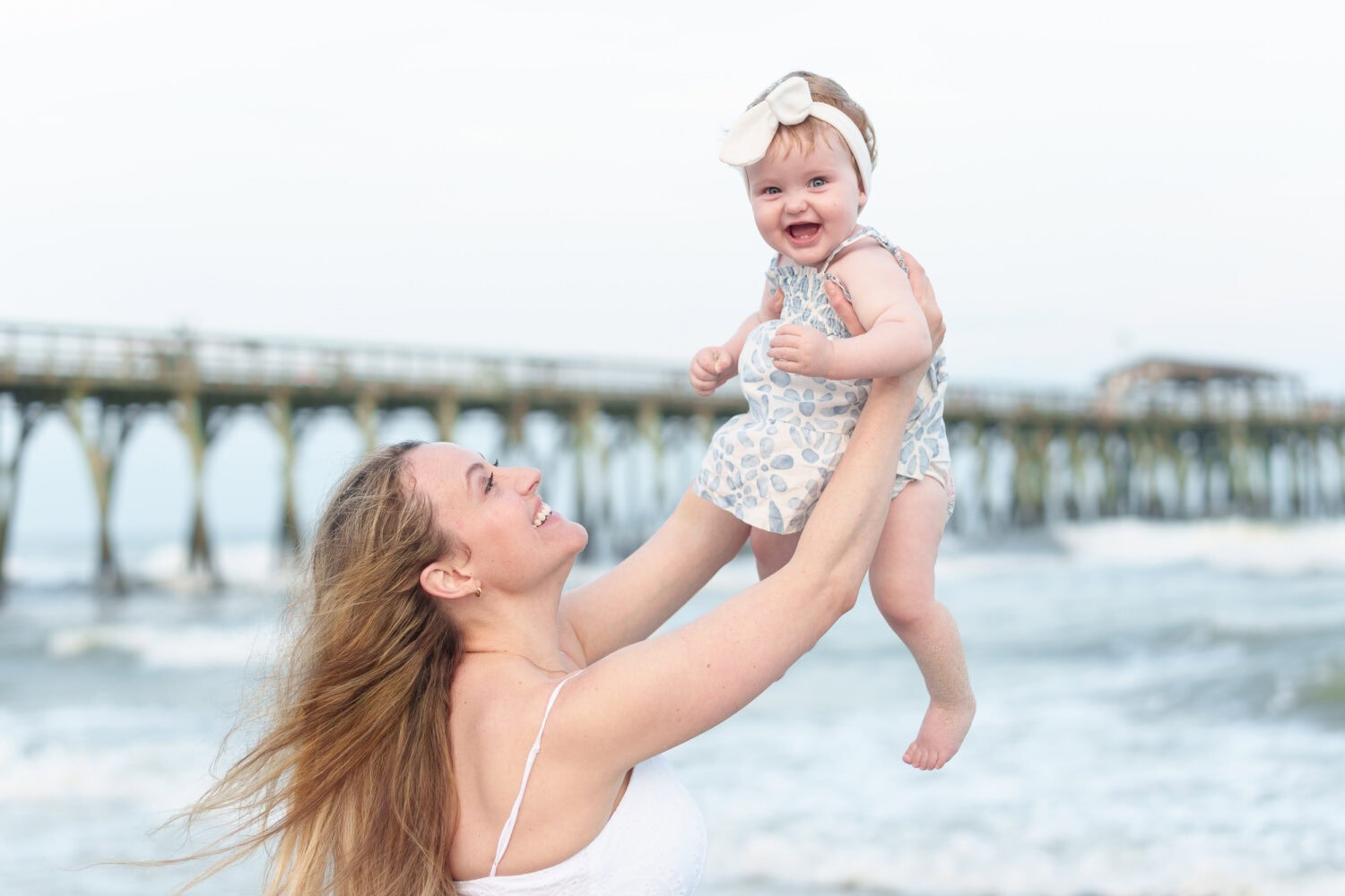 Mom holding baby daughter in the air - Myrtle Beach State Park