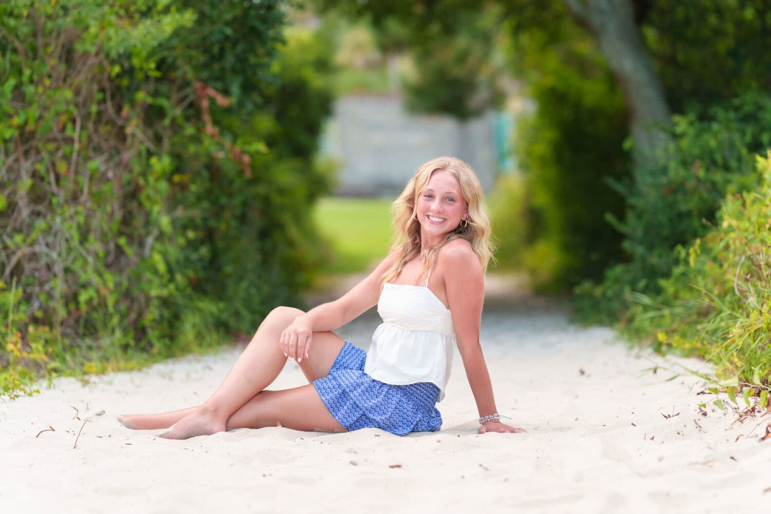 Senior portrait laying on the path to the beach - Huntington Beach State Park