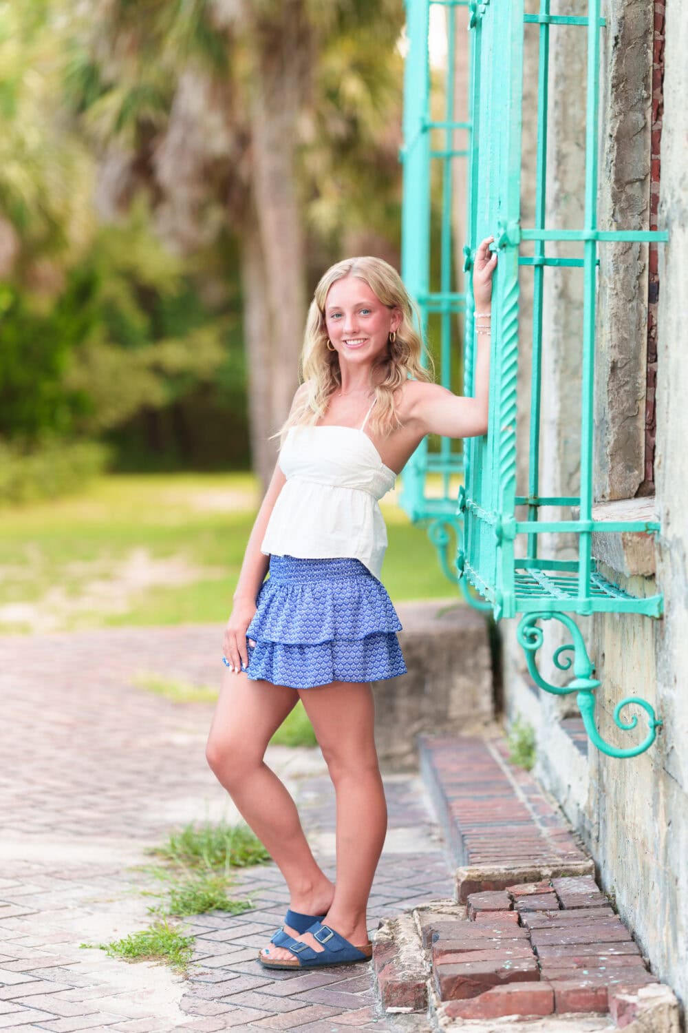 Senior portrait leaning against the window of the Atalaya Castle - Huntington Beach State Park