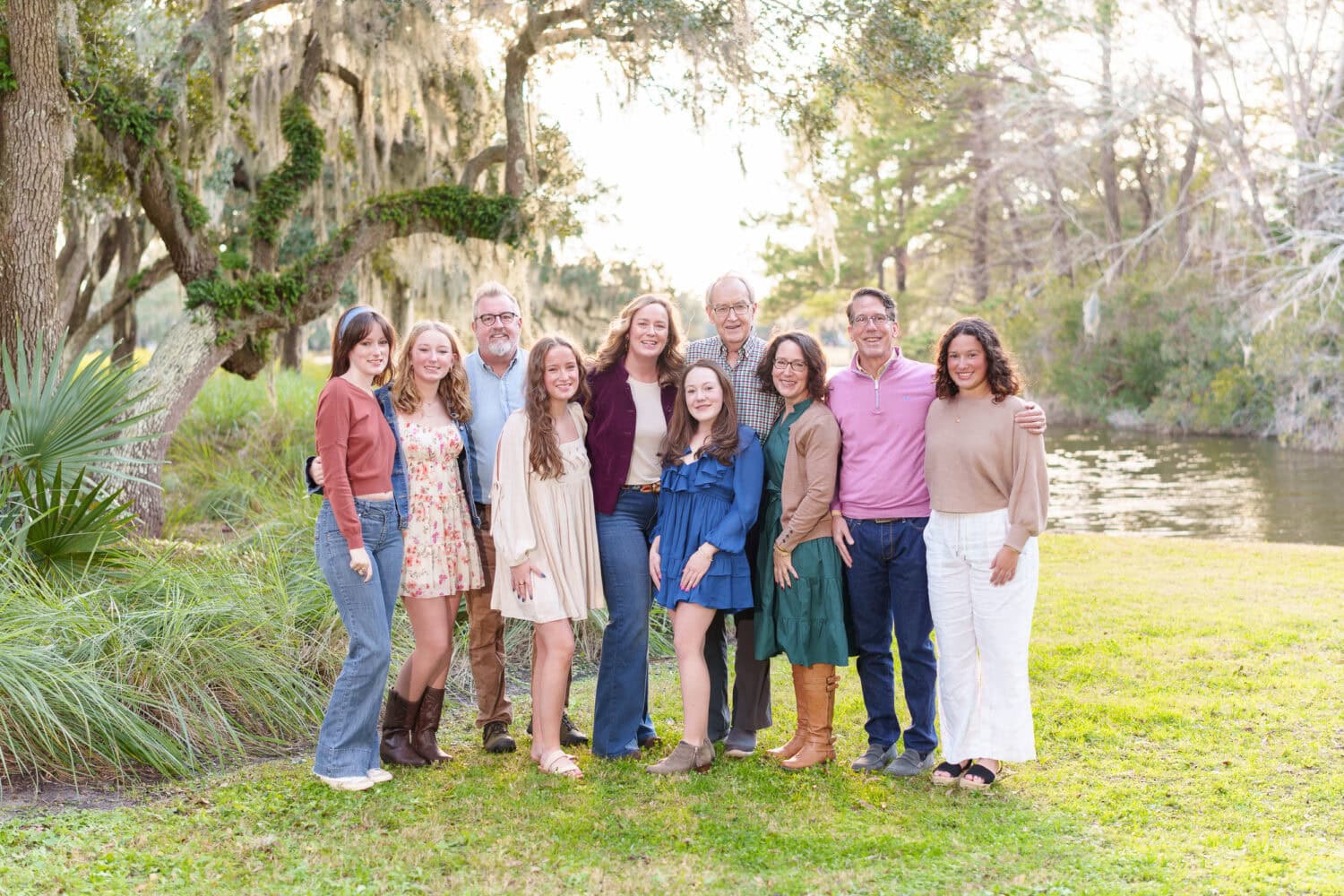 Beautiful sunset with a family in front of the golf course trees - DeBordieu Colony