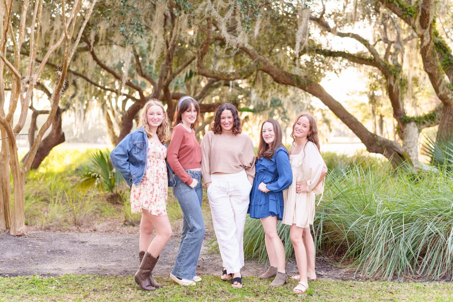 Beautiful sunset with a family in front of the golf course trees - DeBordieu Colony