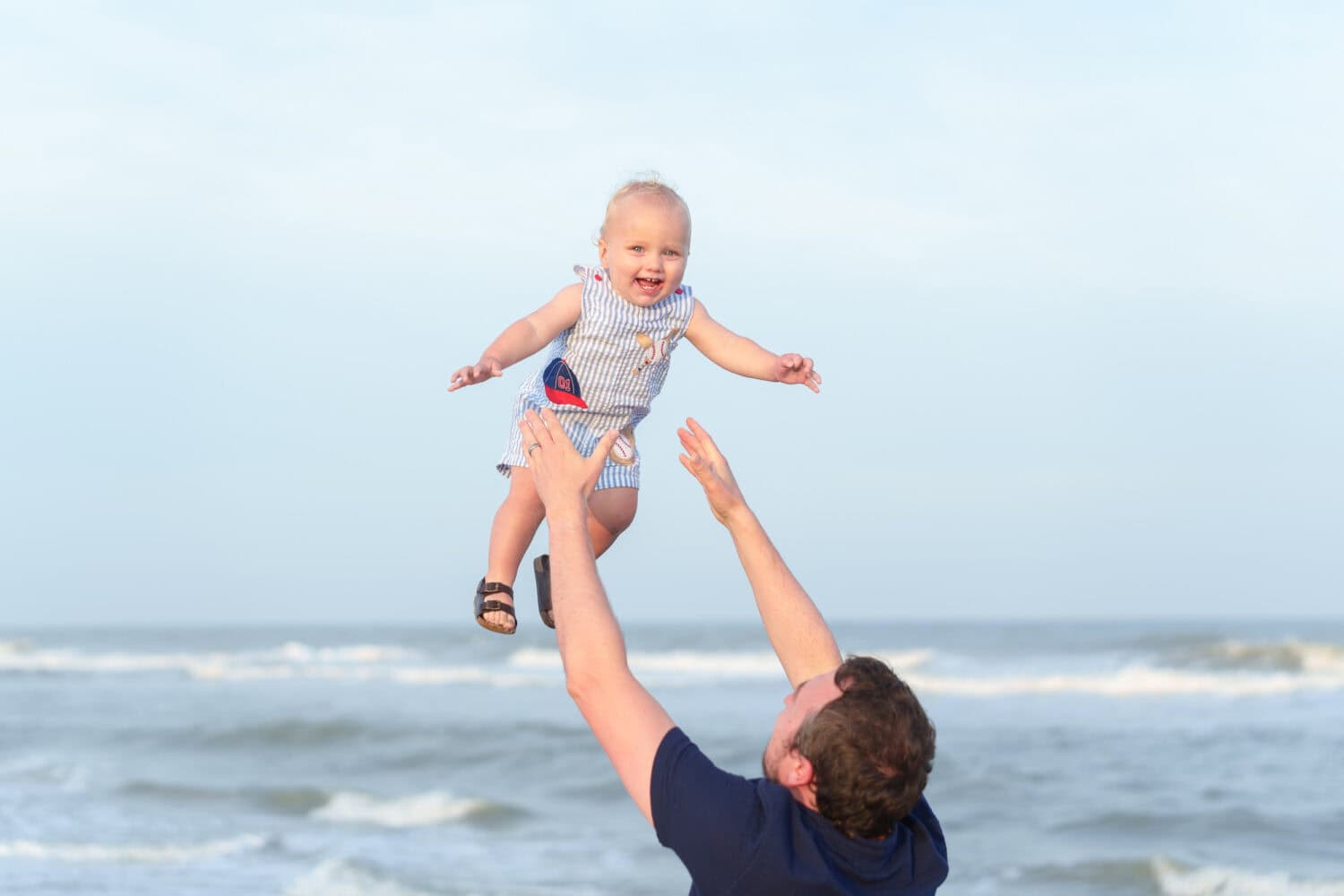 Dad throwing baby boy in the air - Huntington Beach State Park - Pawleys Island