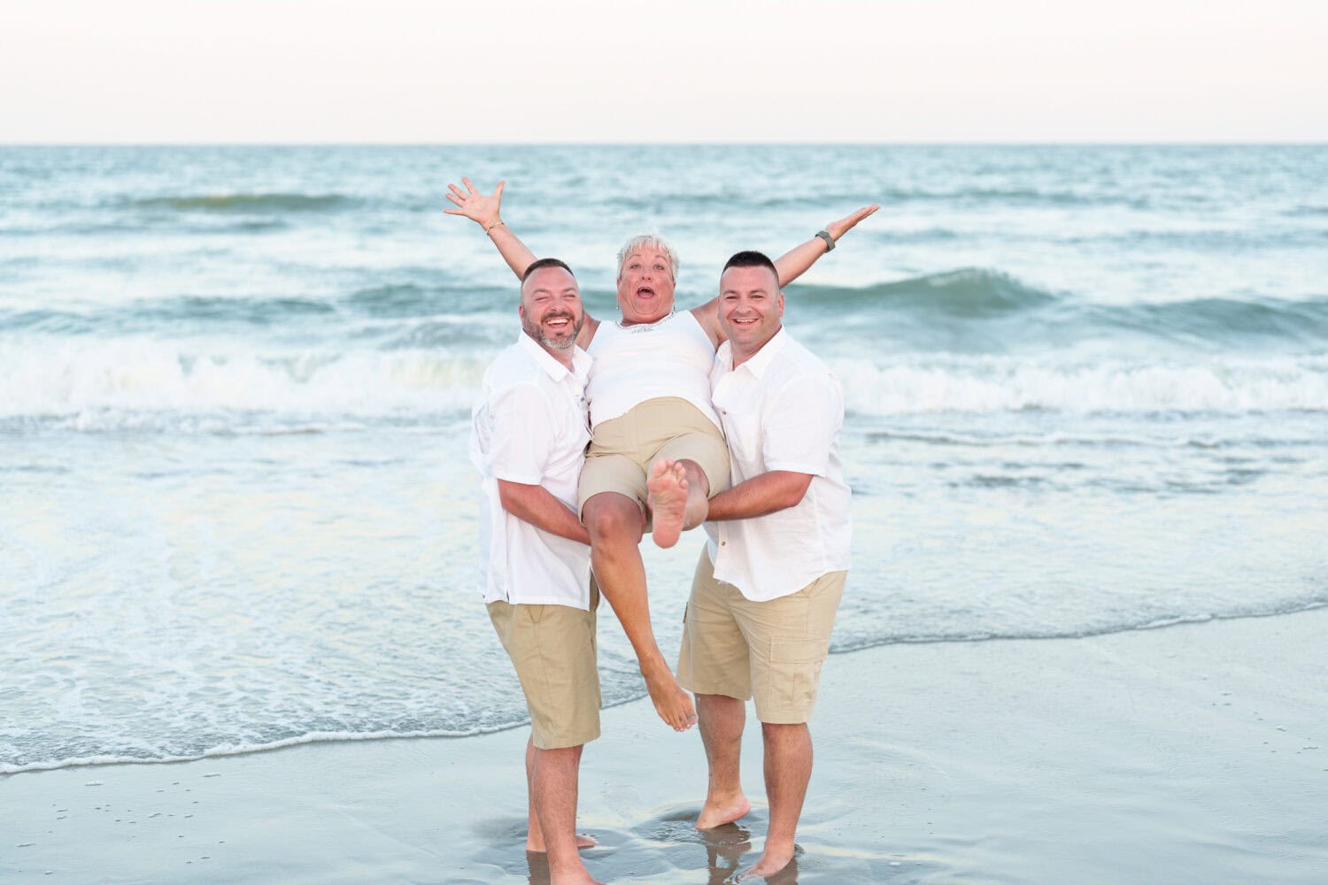 Family pictures with cute toddlers behind their beach house -