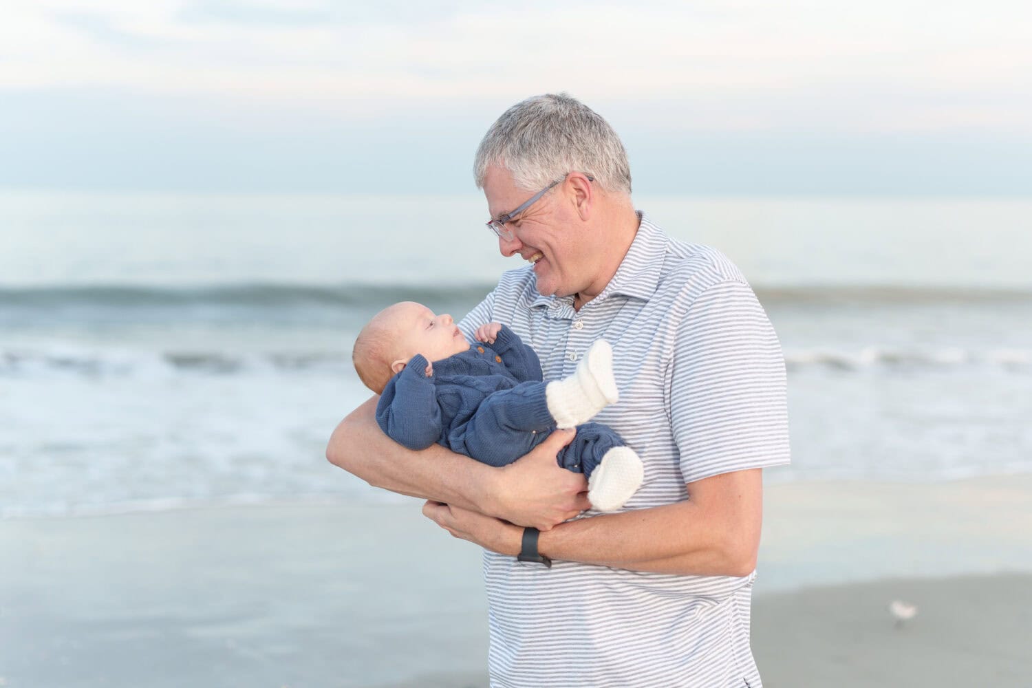 Grandad holding his grandson - Huntington Beach State Park