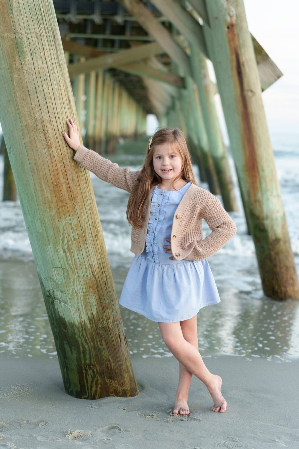 Little girl leaning against the pier - Myrtle Beach State Park