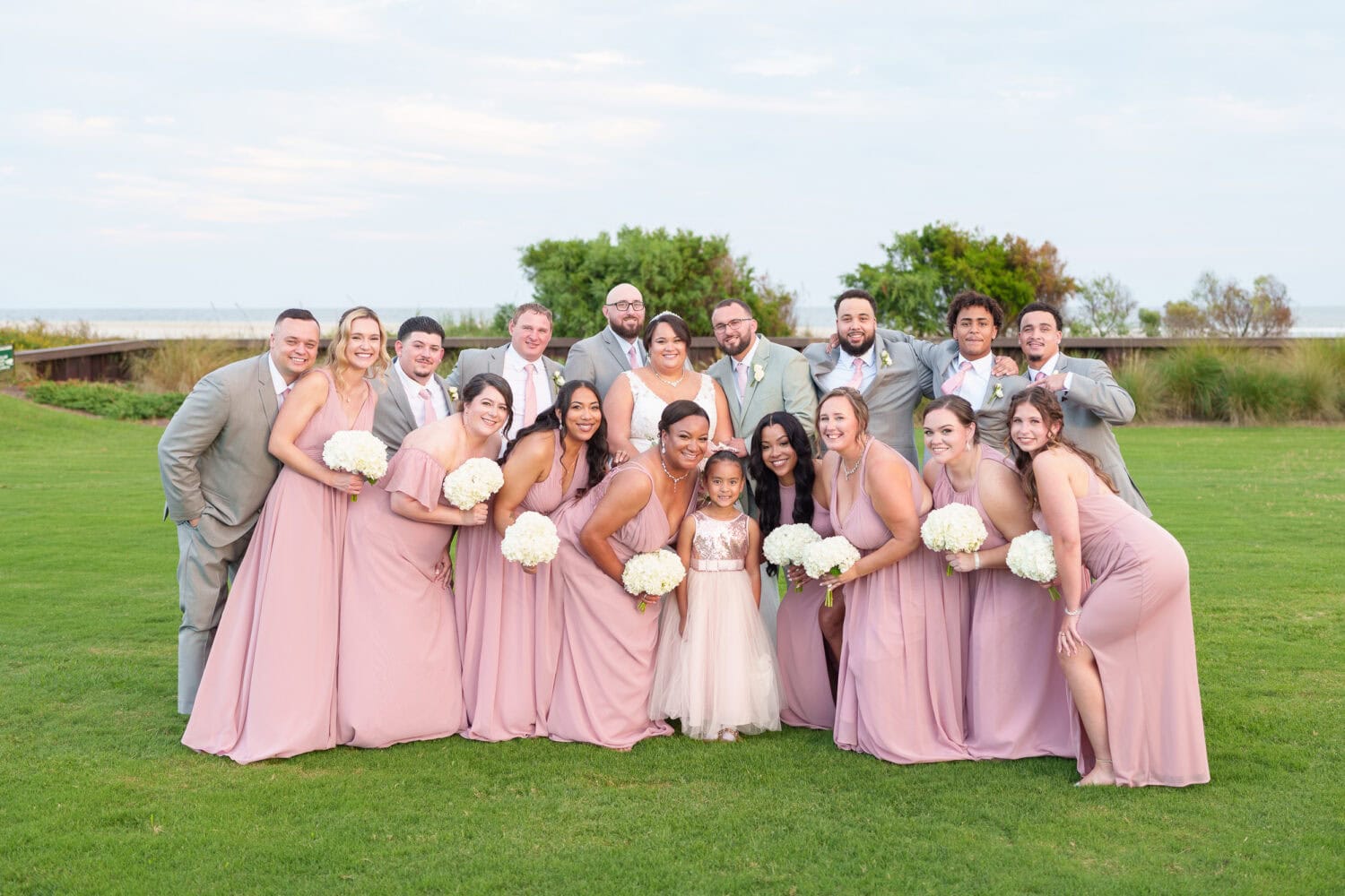 All the wedding party leaning in together - Dunes Golf & Beach Club