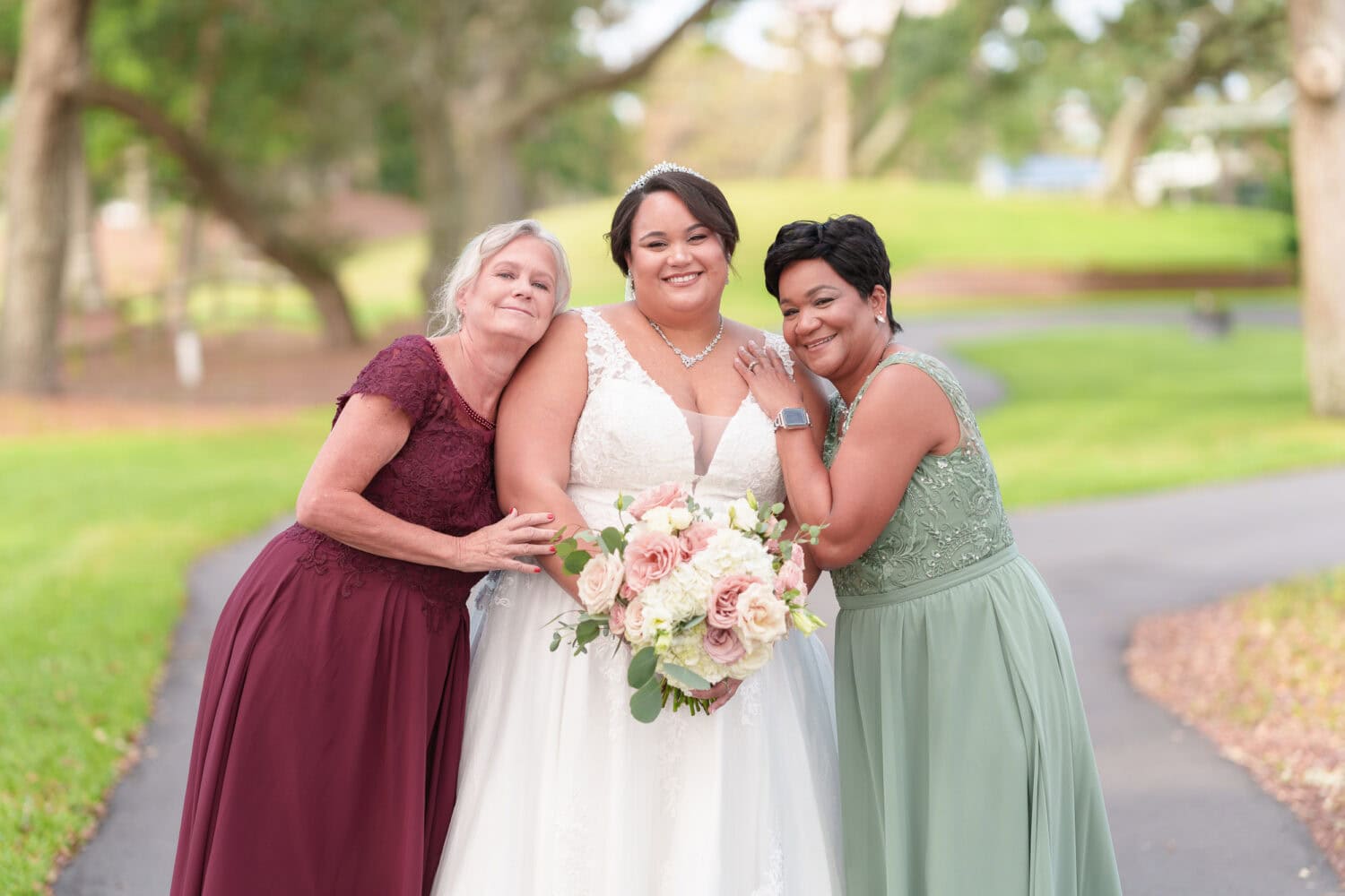 Bride hugging both mothers - Dunes Golf & Beach Club