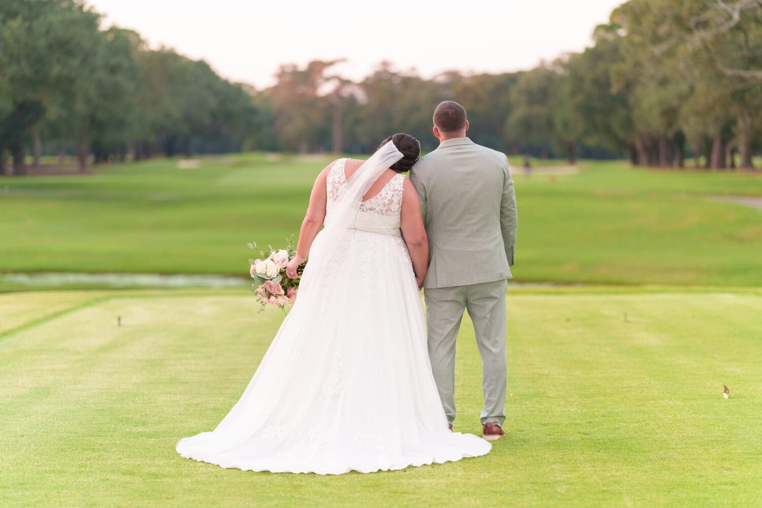 Bride laying her head on his shoulder - Dunes Golf & Beach Club