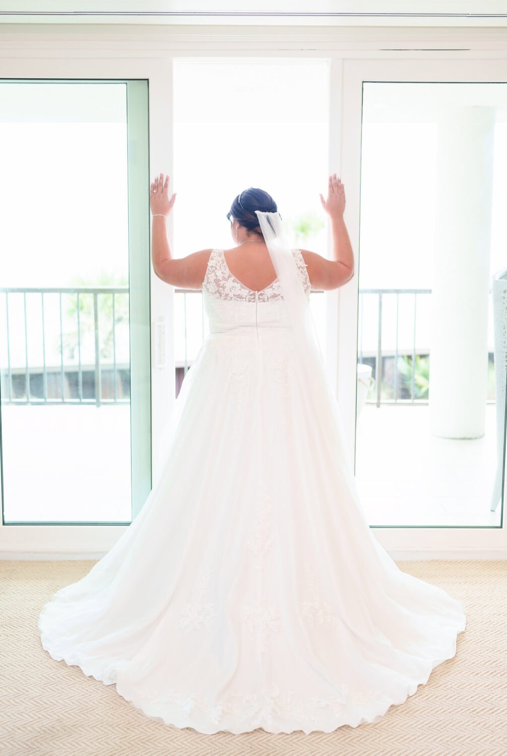 Bride standing in the light of the doorway - Dunes Golf & Beach Club