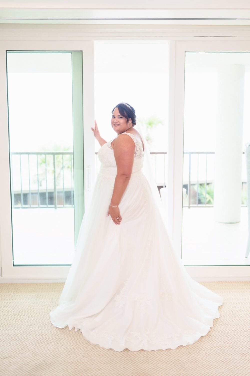 Bride standing in the light of the doorway - Dunes Golf & Beach Club