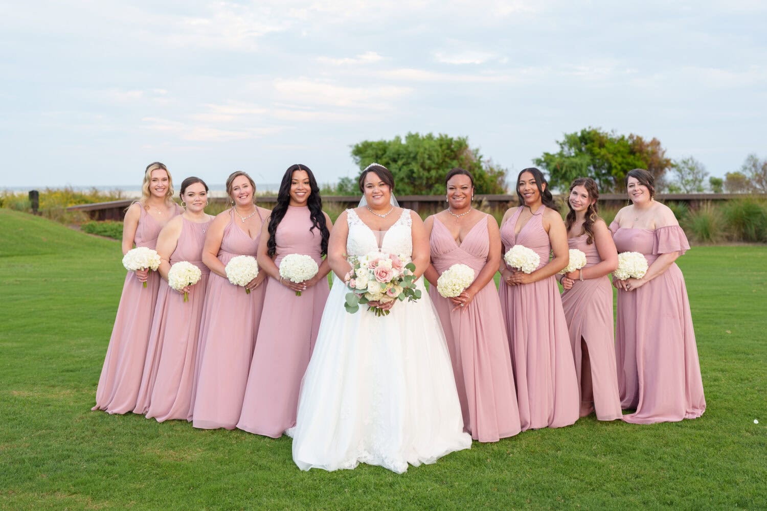 Bridesmaids in a V shape pose - Dunes Golf & Beach Club