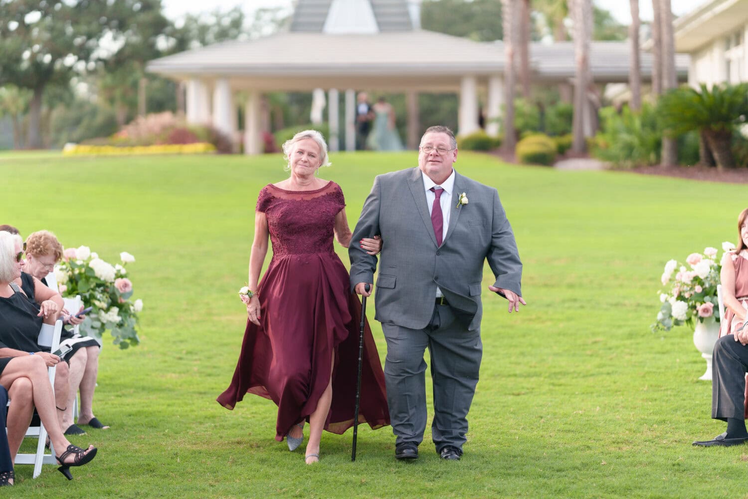 Family and wedding party walking to the ceremony - Dunes Golf & Beach Club