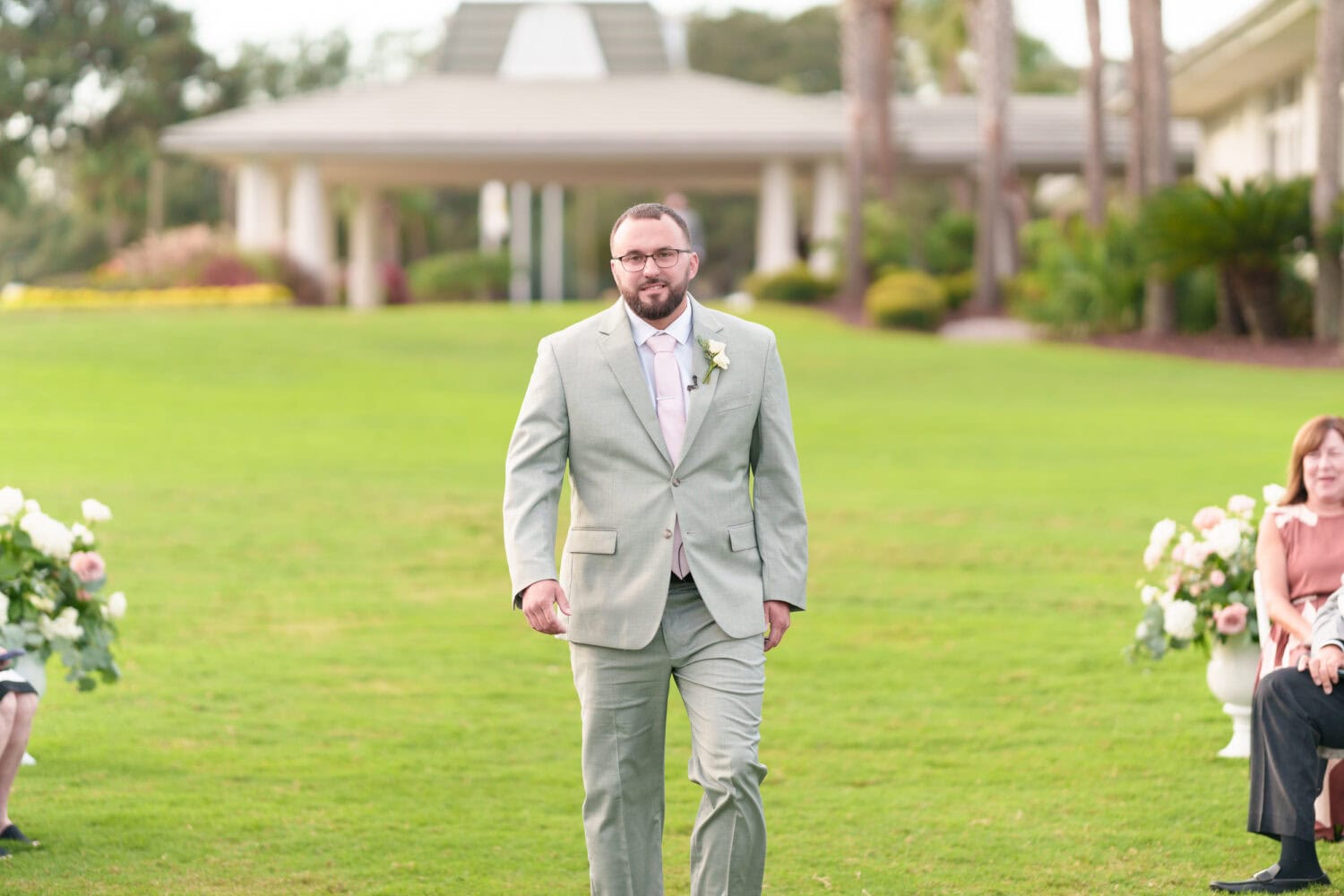 Family and wedding party walking to the ceremony - Dunes Golf & Beach Club