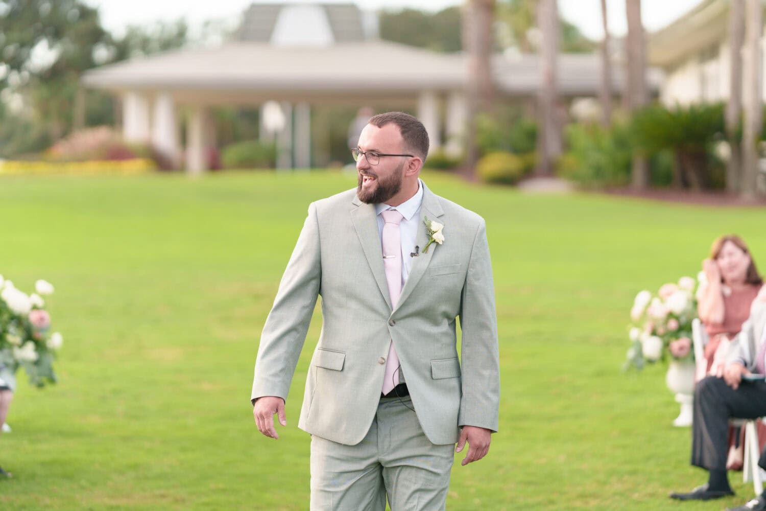 Family and wedding party walking to the ceremony - Dunes Golf & Beach Club