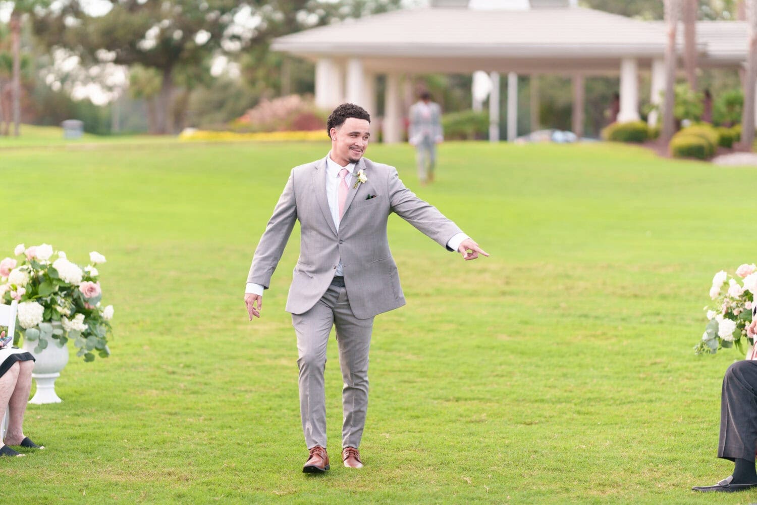 Family and wedding party walking to the ceremony - Dunes Golf & Beach Club