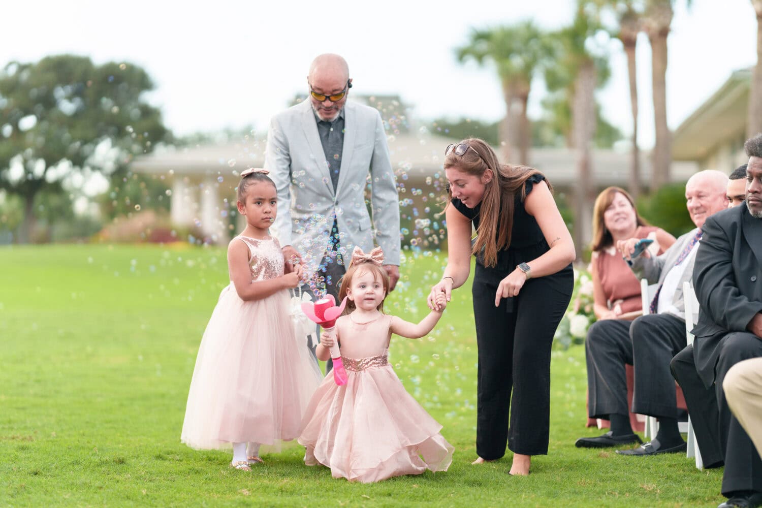 Flower girls holding the bubble machines - Dunes Golf & Beach Club