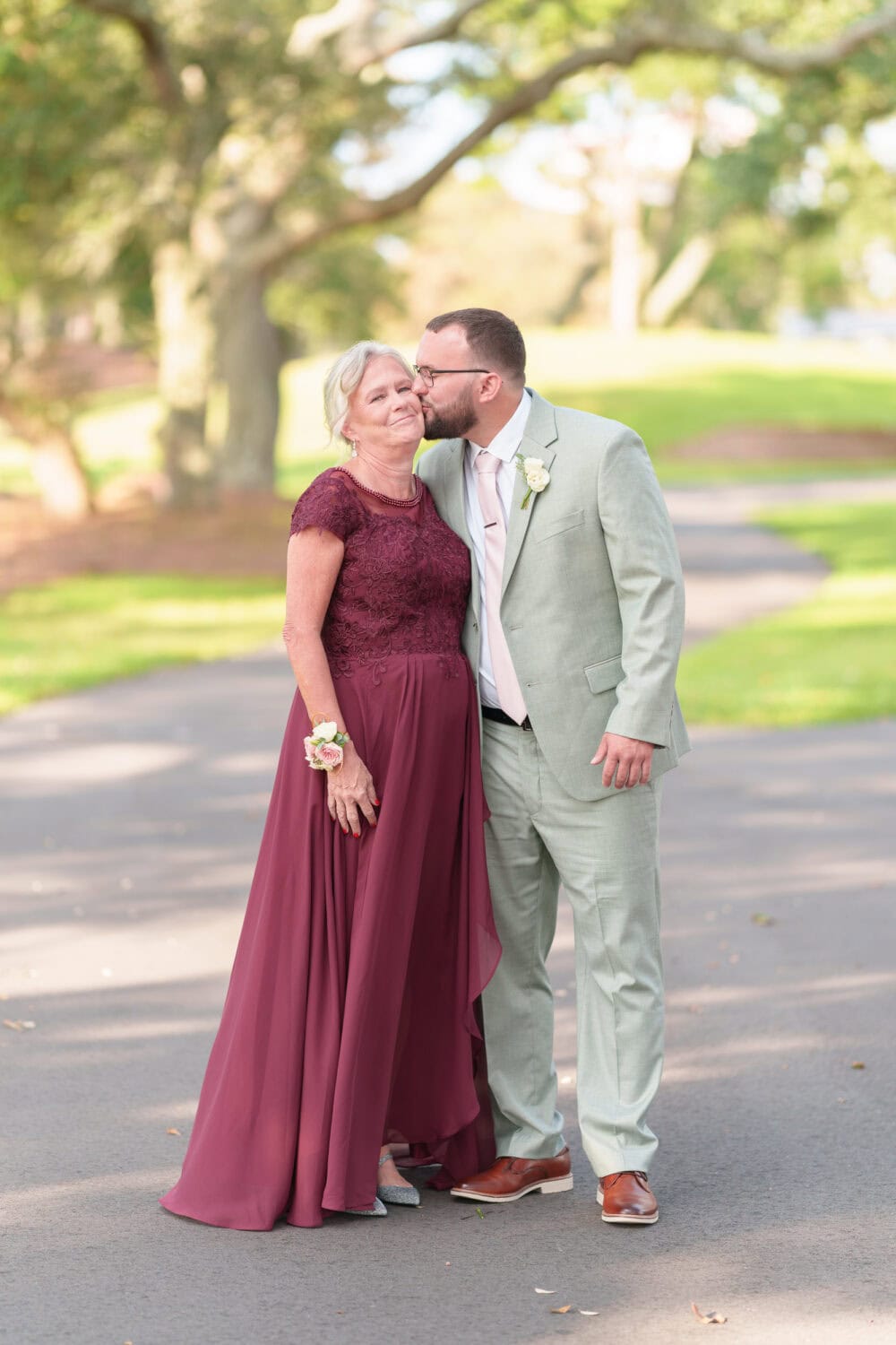 Groom kissing mom on the cheek - Dunes Golf & Beach Club