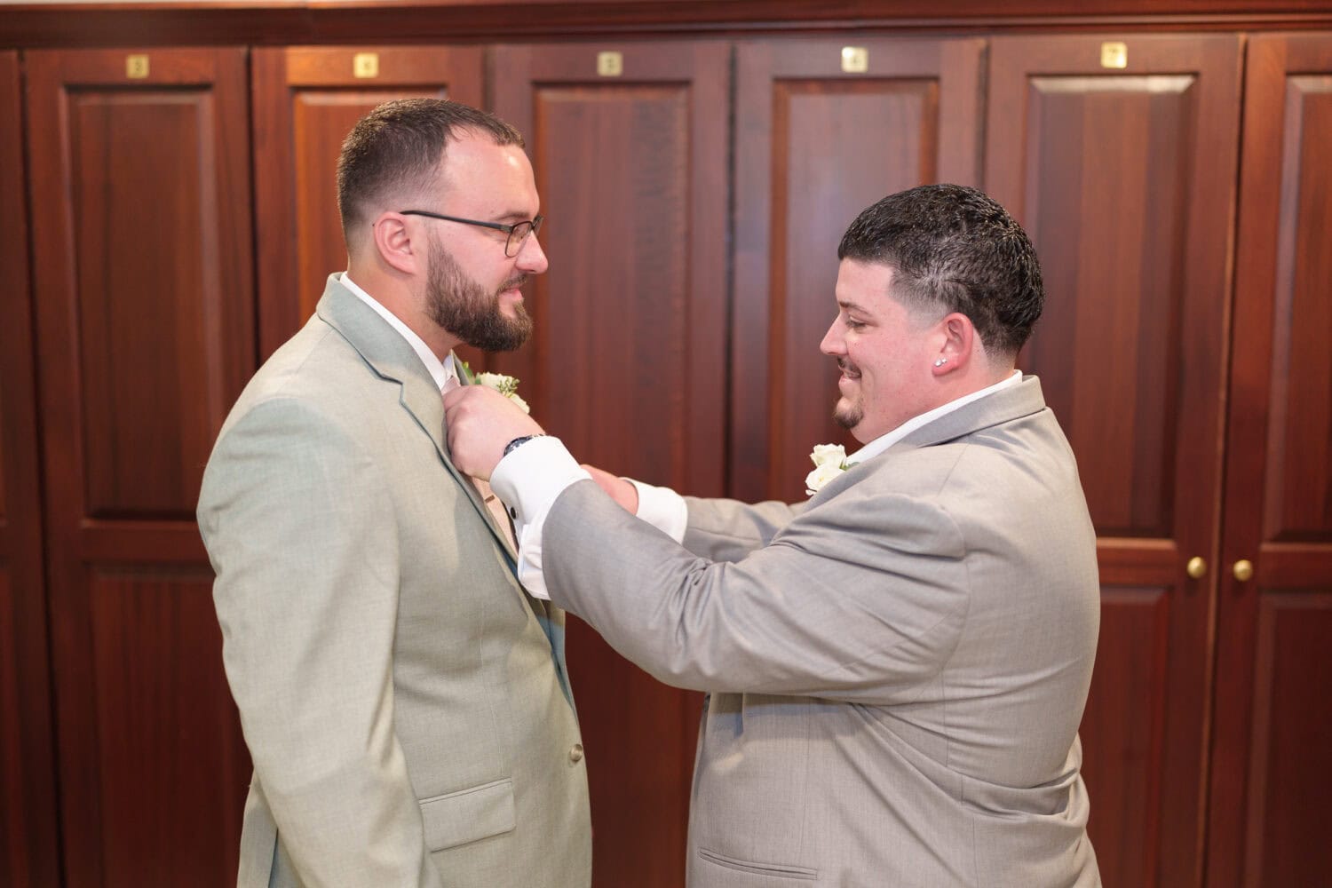 Helping groom with his tie - Dunes Golf & Beach Club