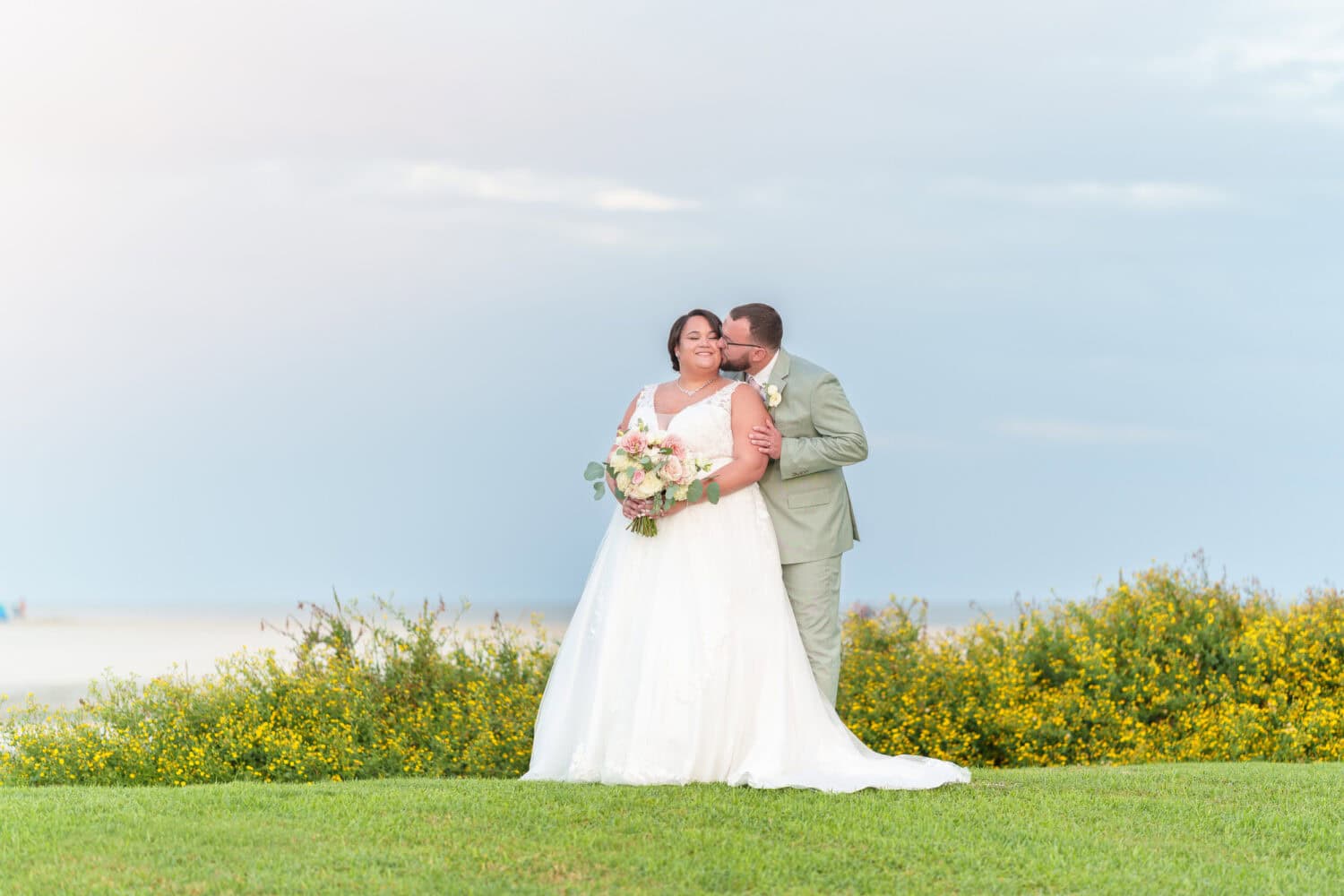 Kiss on the cheek in front of the ocean - Dunes Golf & Beach Club