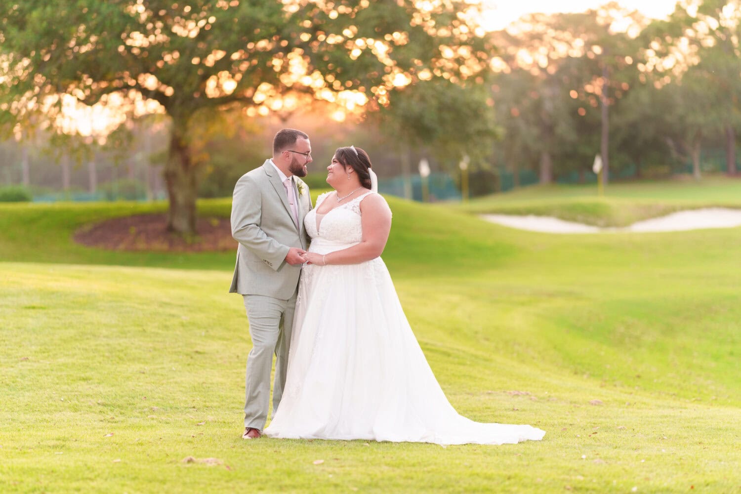 Looking into each others eyes backlit by the sunset filtering through the trees - Dunes Golf & Beach Club