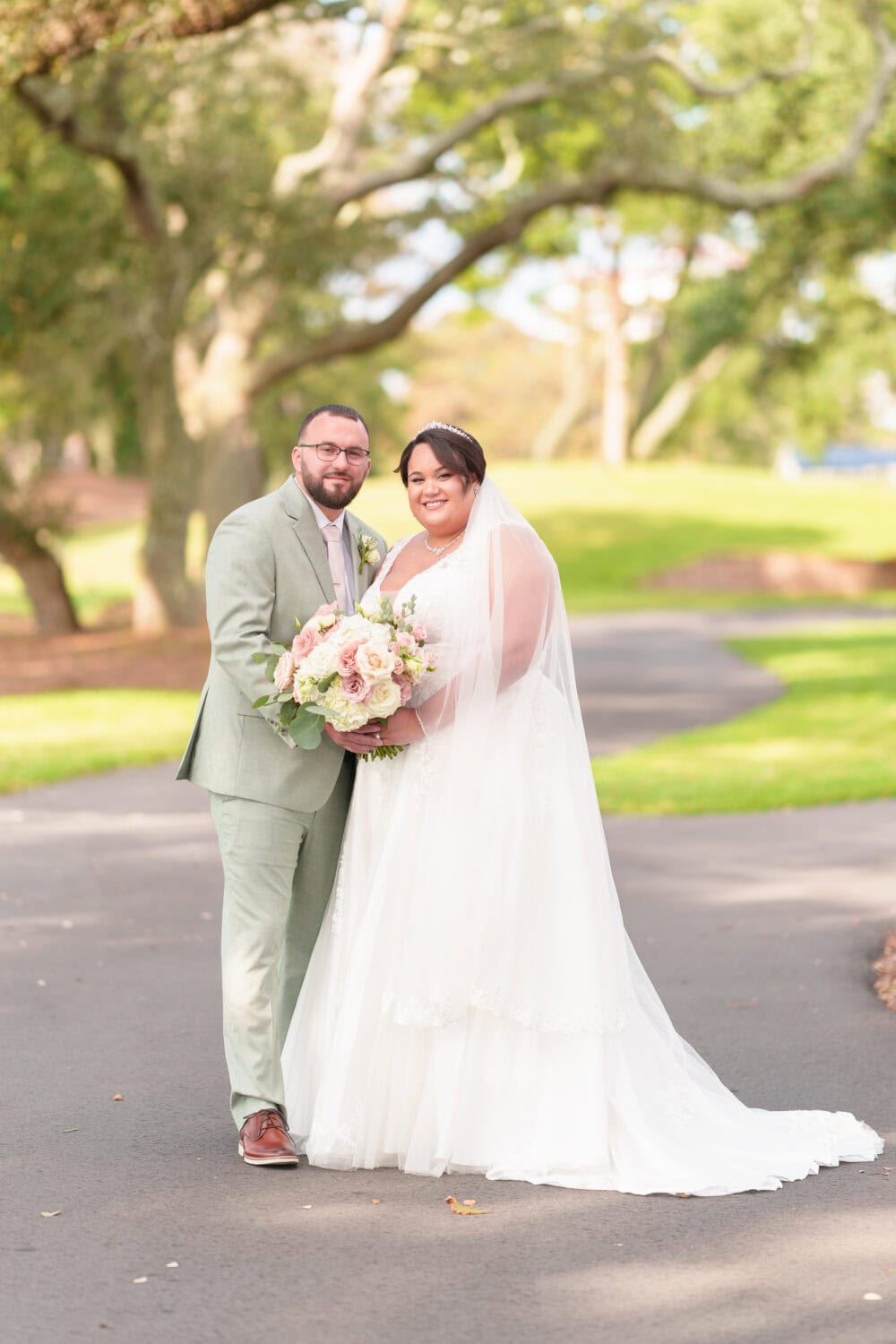 Portraits of the bride and groom under the shade of the oaks besides the clubhouse - Dunes Golf & Beach Club