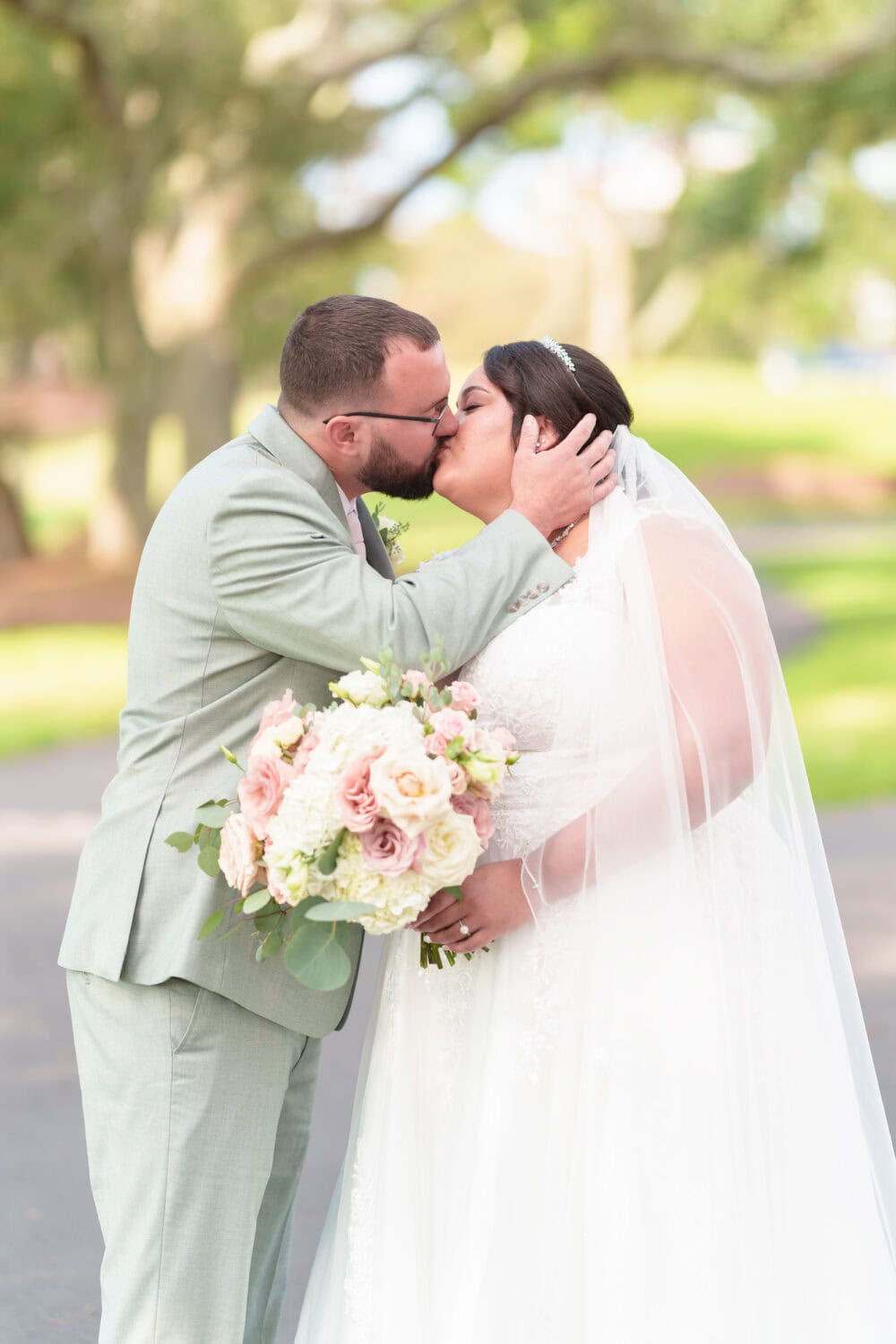 Portraits of the bride and groom under the shade of the oaks besides the clubhouse - Dunes Golf & Beach Club