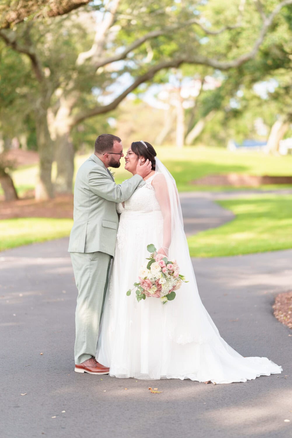 Portraits of the bride and groom under the shade of the oaks besides the clubhouse - Dunes Golf & Beach Club