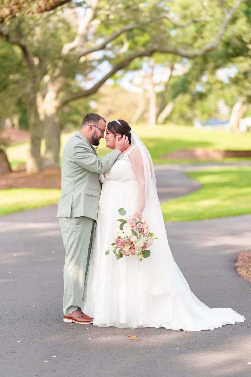 Portraits of the bride and groom under the shade of the oaks besides the clubhouse - Dunes Golf & Beach Club